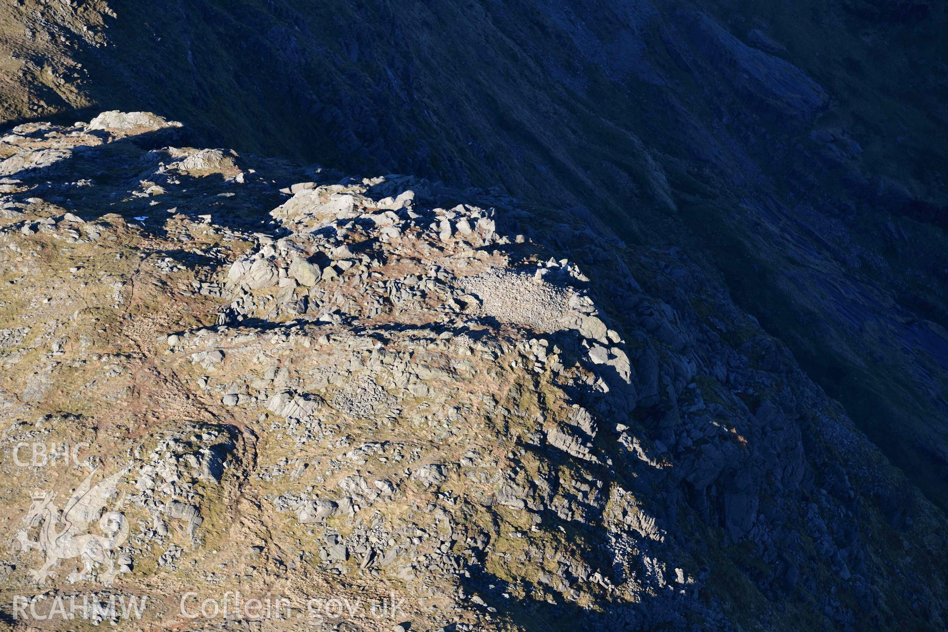 Oblique aerial photograph of Aran Fawddwy cairn and trig point taken during the Royal Commission’s programme of archaeological aerial reconnaissance by Toby Driver on 17th January 2022