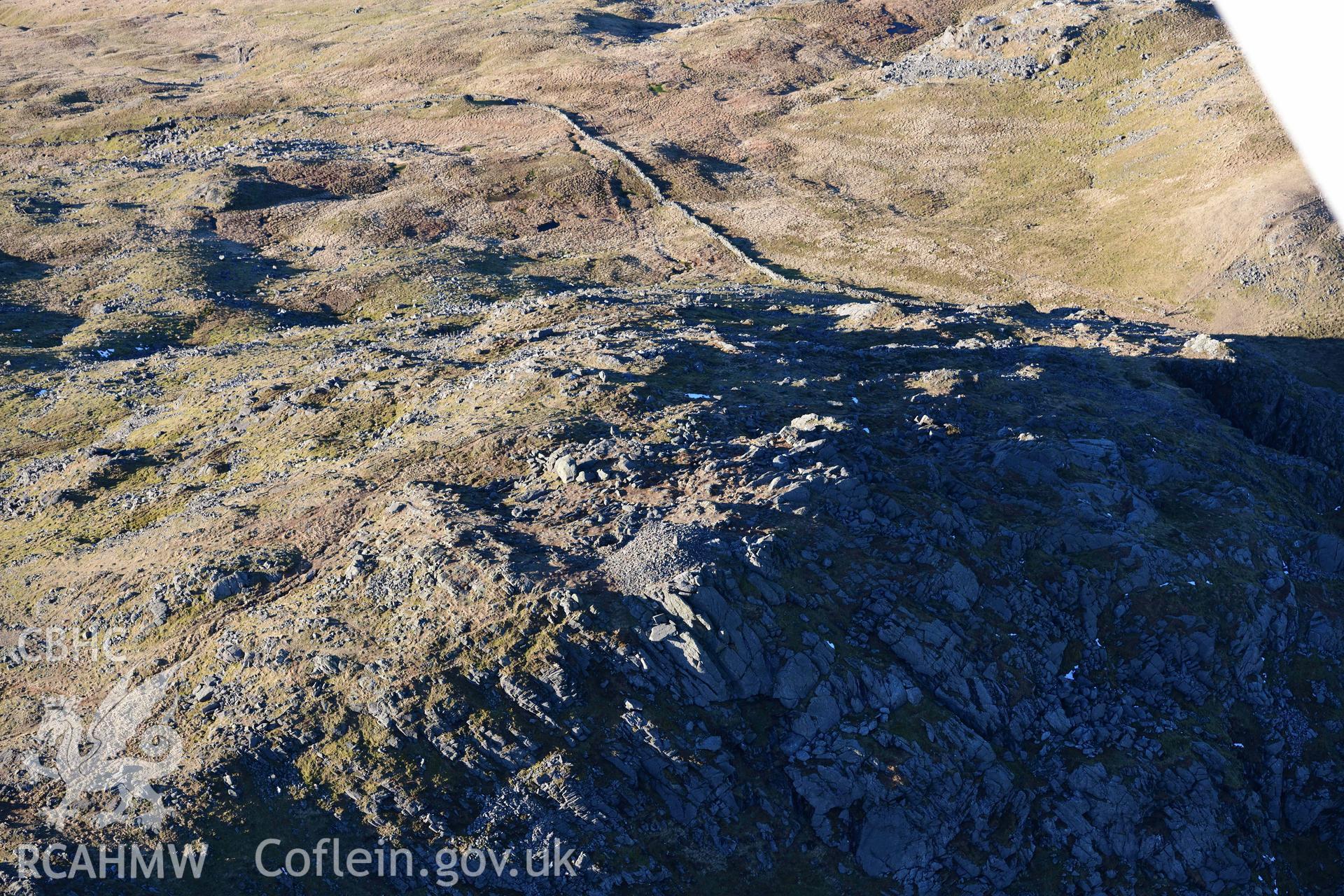 Oblique aerial photograph of Aran Fawddwy cairn and trig point taken during the Royal Commission’s programme of archaeological aerial reconnaissance by Toby Driver on 17th January 2022
