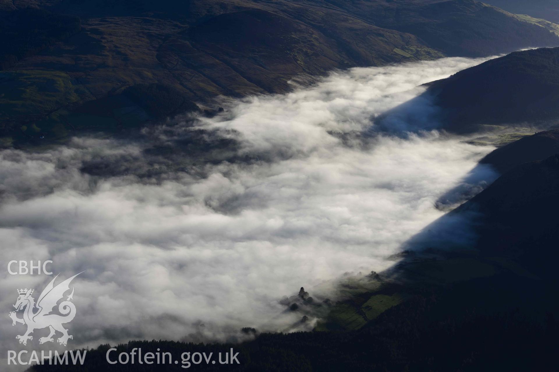 Oblique aerial photograph of cloud inversion west of Llanuwchllyn, viewed from the north. Taken during the Royal Commission’s programme of archaeological aerial reconnaissance by Toby Driver on 17th January 2022