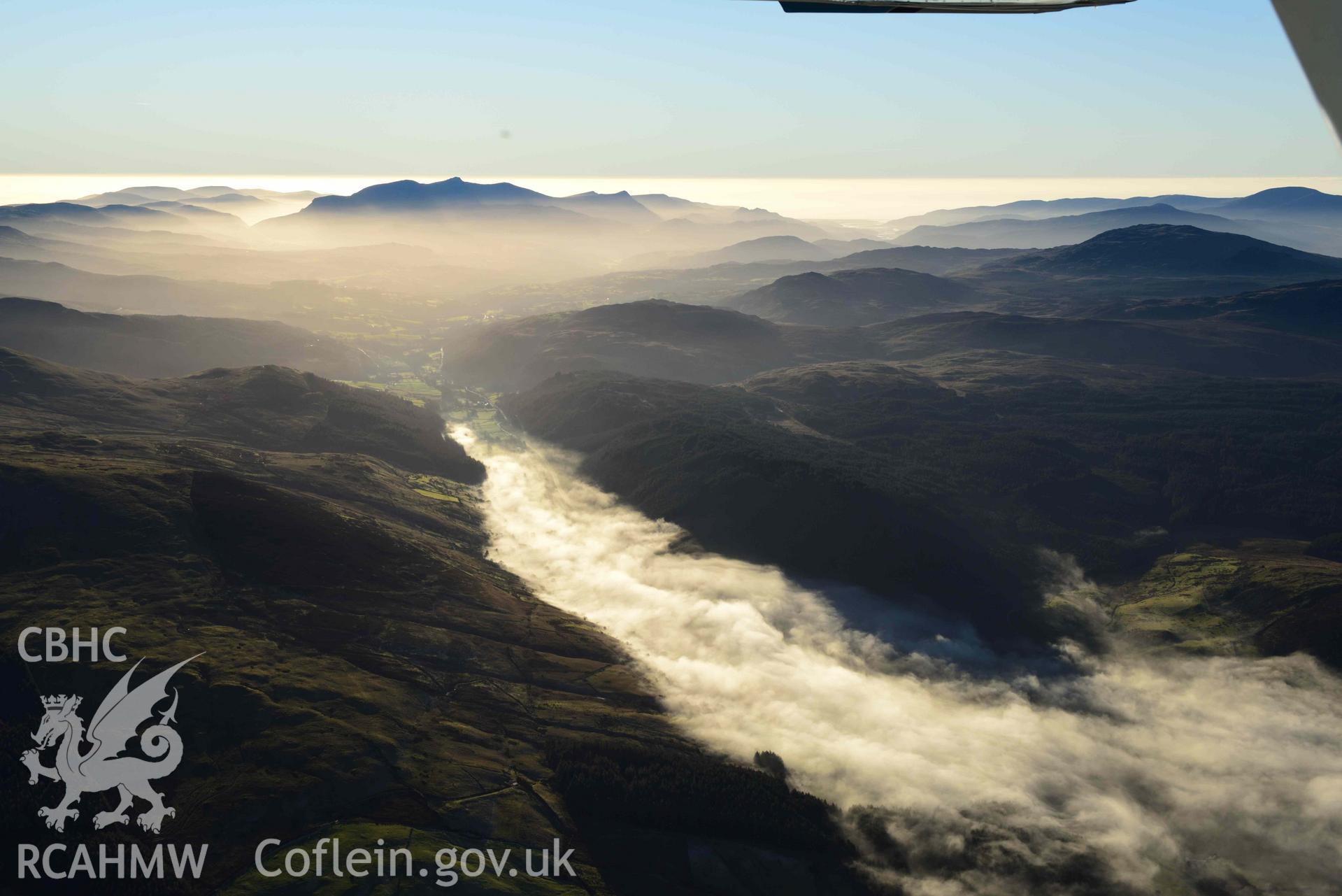 Oblique aerial photograph of Cader Idris winter landscape with cloud inversion at Llanuwchllyn. Taken from the north east during the Royal Commission’s programme of archaeological aerial reconnaissance by Toby Driver on 17th January 2022