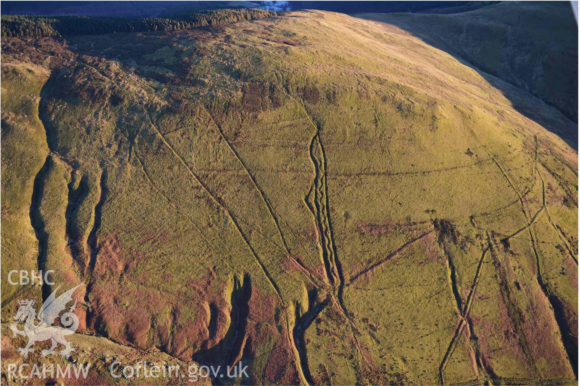 Oblique aerial photograph of Mynydd Fron-fraith zig-zag peat sledway and landscape taken conducted during the Royal Commission’s programme of archaeological aerial reconnaissance by Toby Driver on 17th January 2022