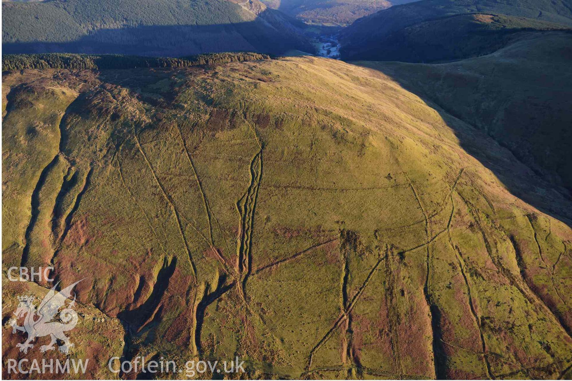 Oblique aerial photograph of Mynydd Fron-fraith zig-zag peat sledway and landscape taken conducted during the Royal Commission’s programme of archaeological aerial reconnaissance by Toby Driver on 17th January 2022