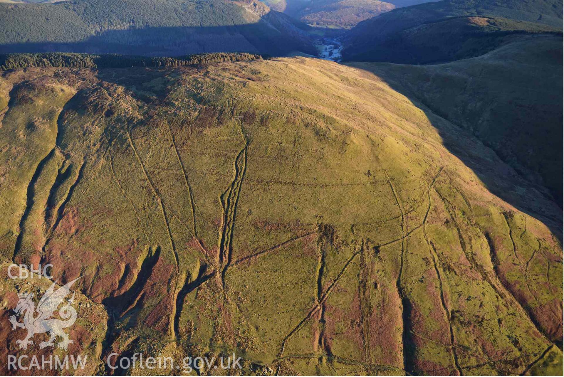 Oblique aerial photograph of Mynydd Fron-fraith zig-zag peat sledway and landscape taken conducted during the Royal Commission’s programme of archaeological aerial reconnaissance by Toby Driver on 17th January 2022