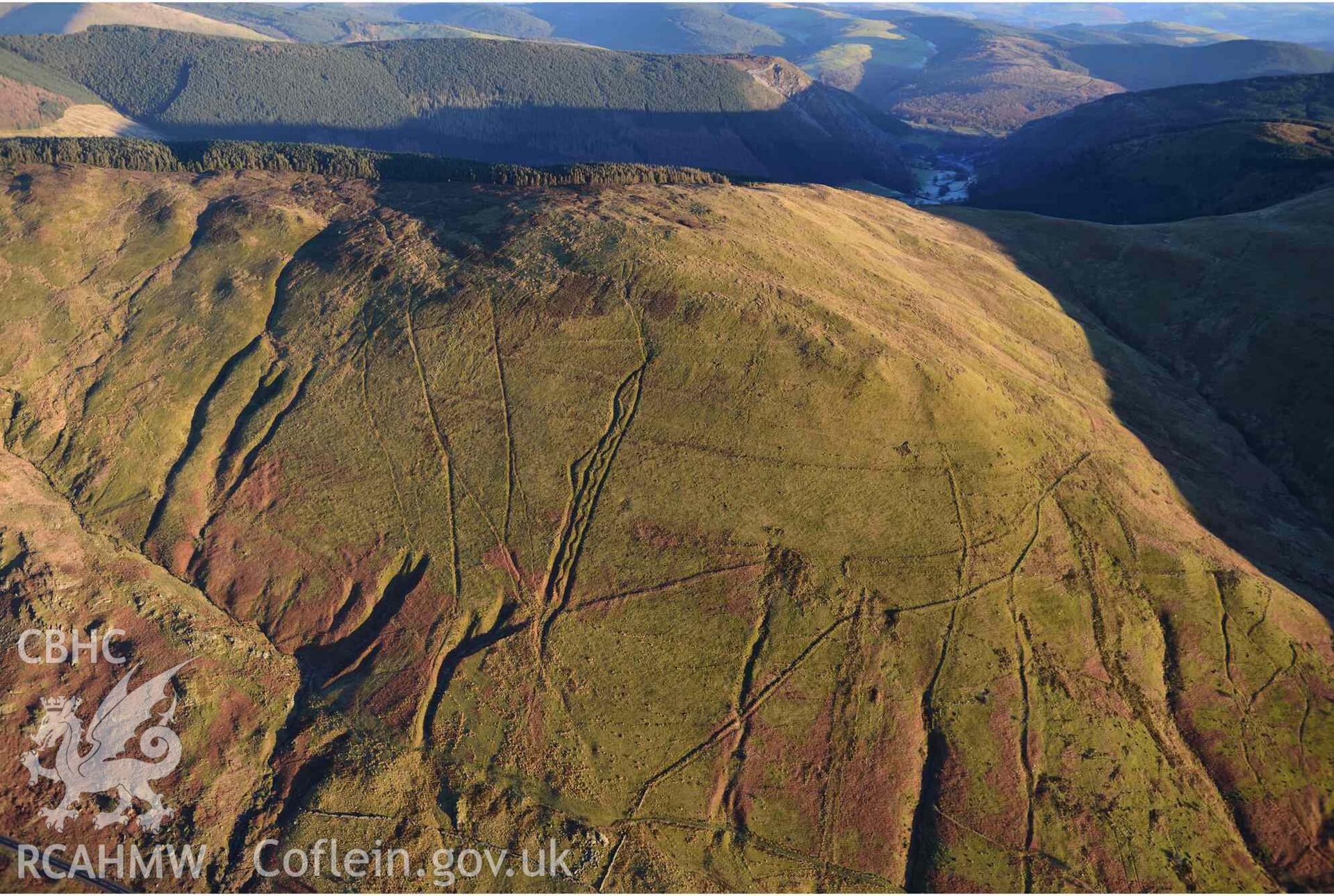 Oblique aerial photograph of Mynydd Fron-fraith zig-zag peat sledway and landscape taken conducted during the Royal Commission’s programme of archaeological aerial reconnaissance by Toby Driver on 17th January 2022