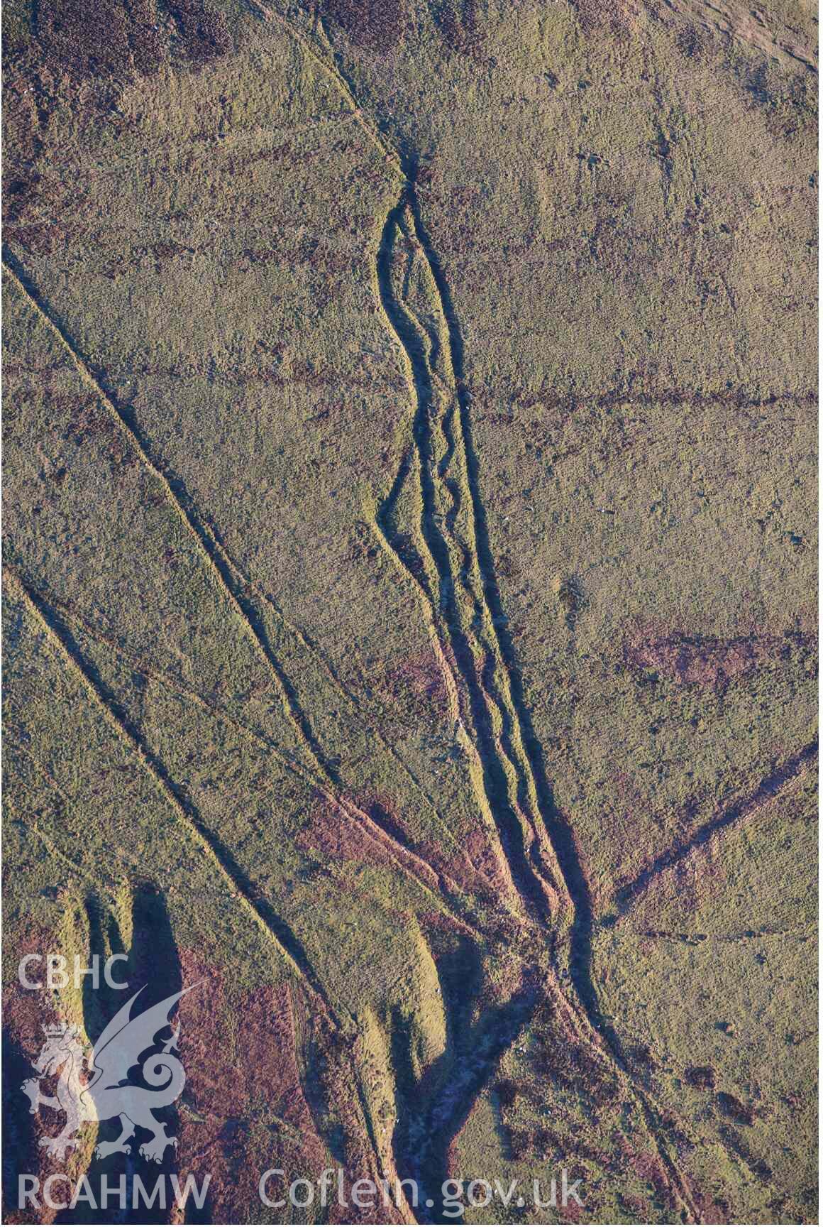 Oblique aerial photograph of Mynydd Fron-fraith zig-zag peat sledway and landscape taken conducted during the Royal Commission’s programme of archaeological aerial reconnaissance by Toby Driver on 17th January 2022