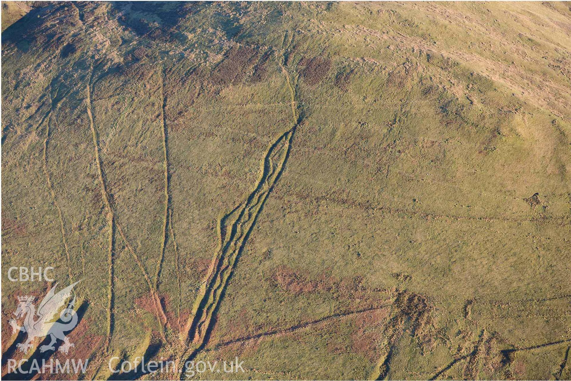 Oblique aerial photograph of Mynydd Fron-fraith zig-zag peat sledway and landscape taken conducted during the Royal Commission’s programme of archaeological aerial reconnaissance by Toby Driver on 17th January 2022