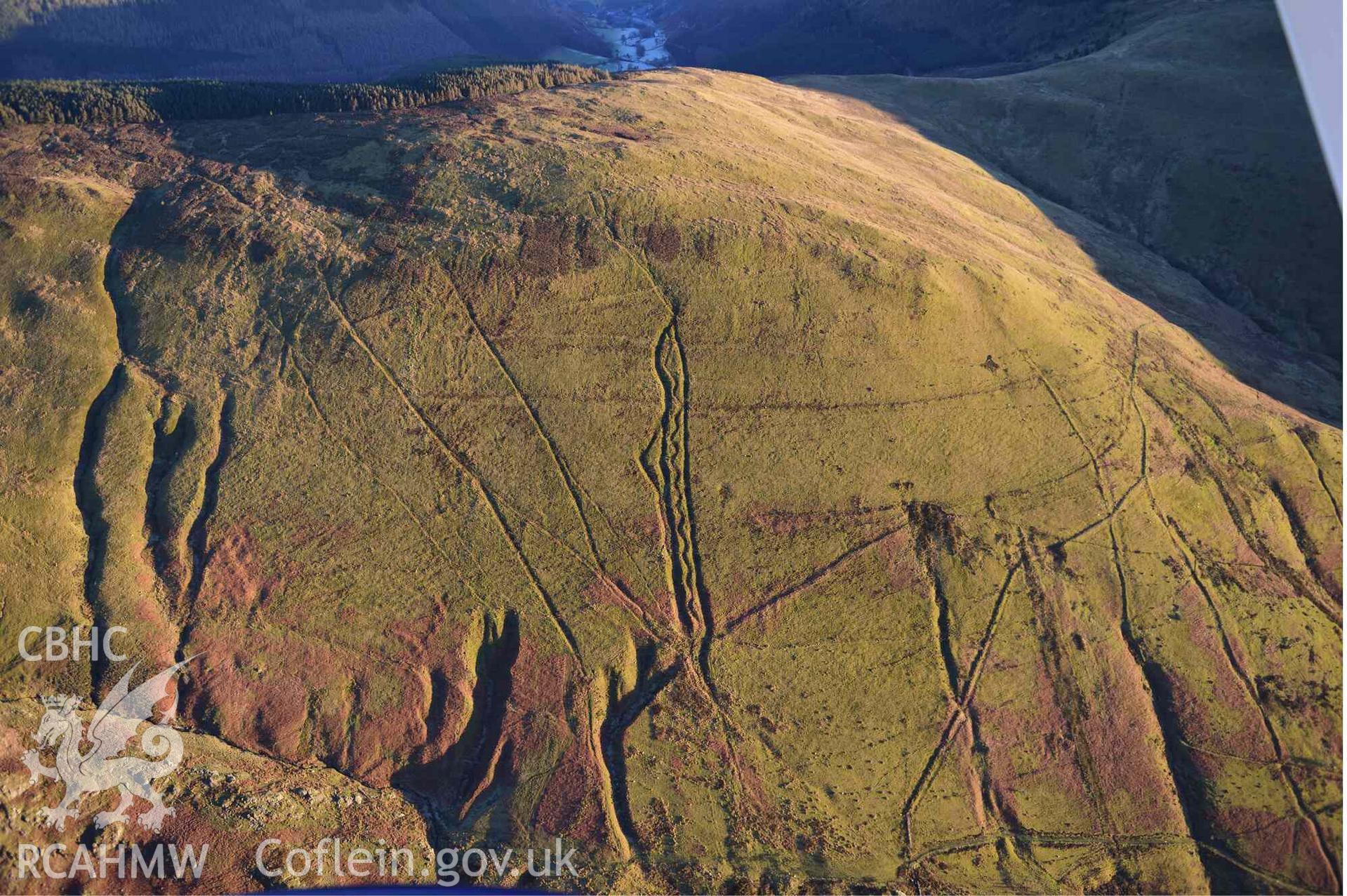 Oblique aerial photograph of Mynydd Fron-fraith zig-zag peat sledway and landscape taken conducted during the Royal Commission’s programme of archaeological aerial reconnaissance by Toby Driver on 17th January 2022