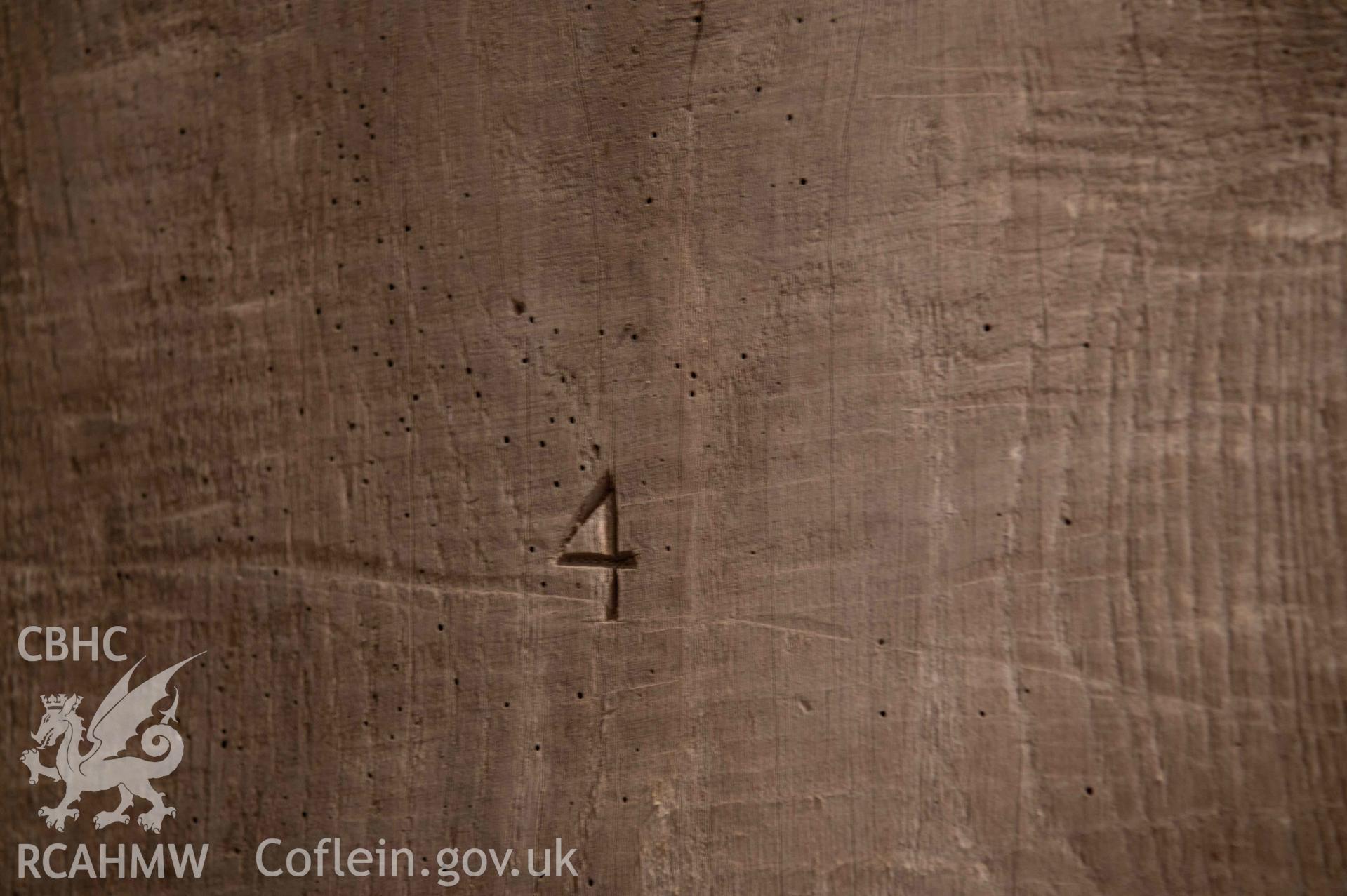 St Michael's Church, Llanfihangel y Creuddyn. Detail of arabic numerals carved into bell-frame.