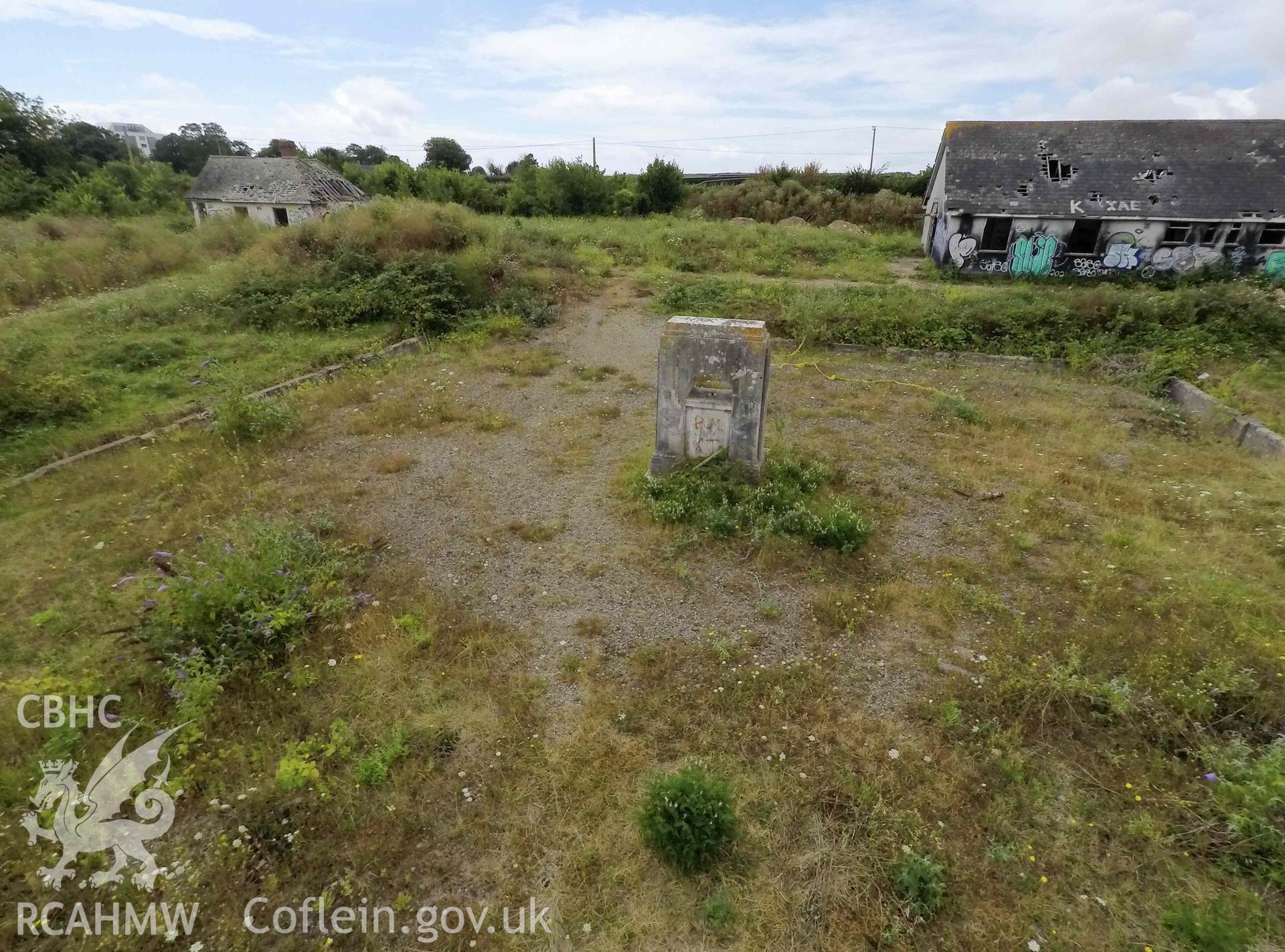 Elevated oblique view looking west. Caretaker's bungalow to the left. War memorial in foreground. St Athan Boys Village.