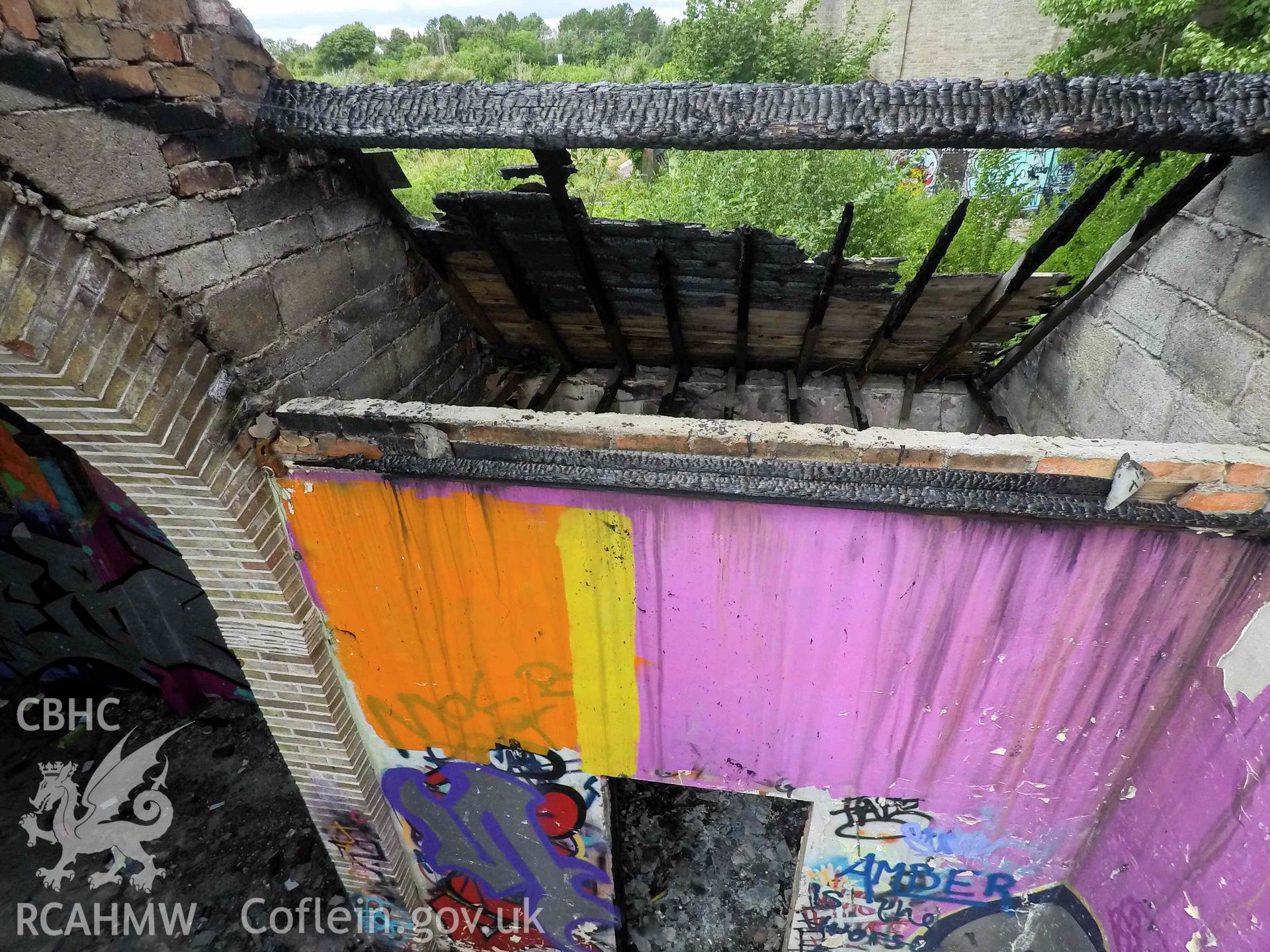Elevated interior of church. Ceiling and roof damage at the chancel, looking north. St Athan Boys Village.