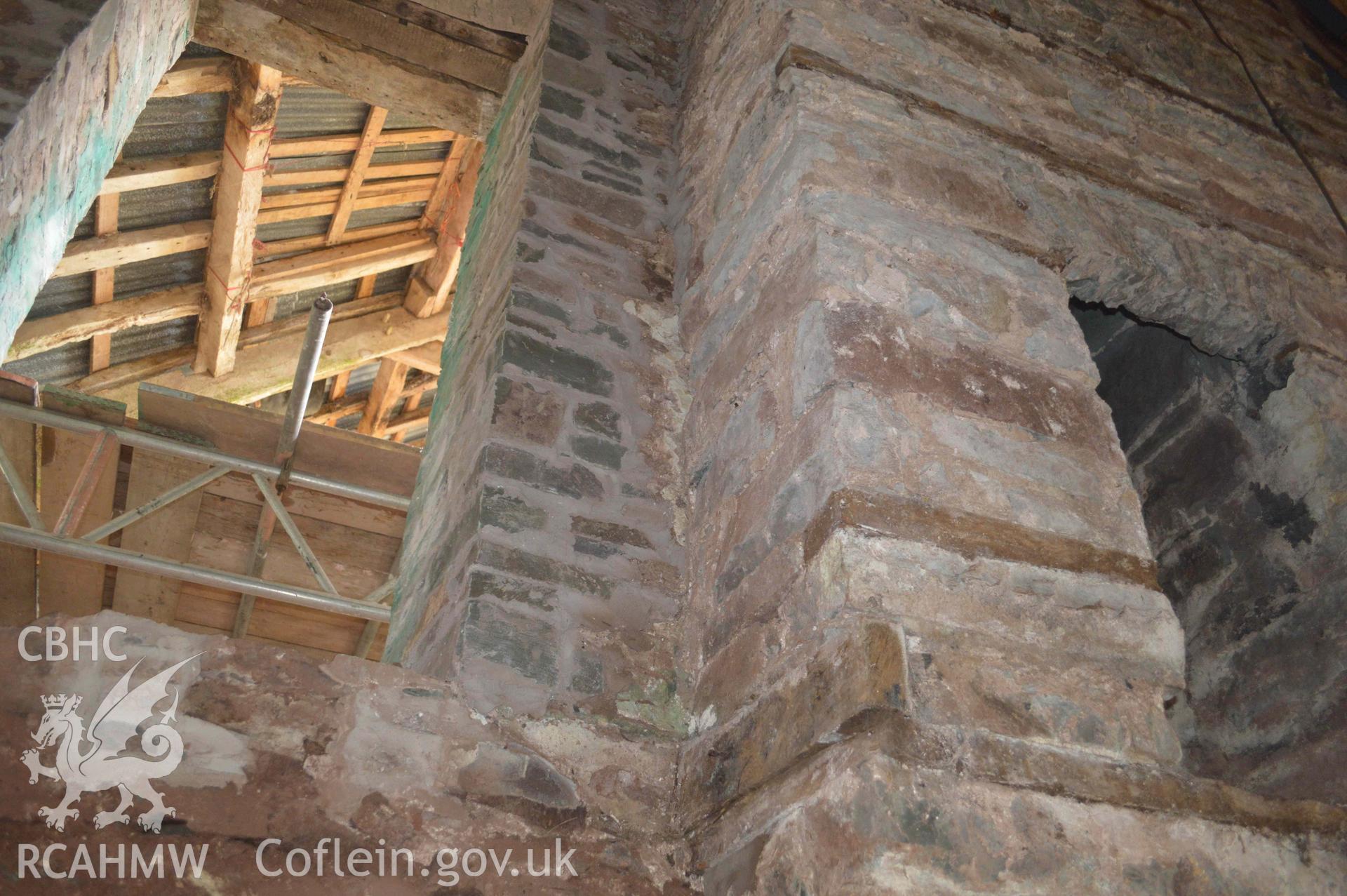 Photograph showing View of render behind fireplace on S gable of house, from a Level 3 historic building recording of Felincamlais Farm, Libanus, carried out by Clwyd-Powys Archaeological Trust in 2022. Report no: 1899, Project no. 2651.