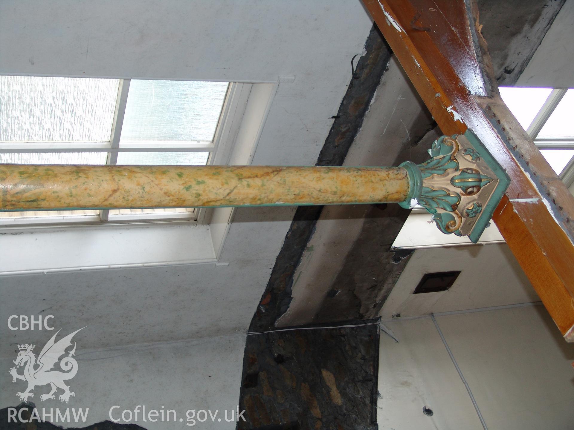 Photograph from a building recording survey: Zion Chapel, High Street, Newbridge, Gwent; detail of original paint work on south eastern cast iron column. Carried out by A. P. A. C. Ltd. in September 2008.