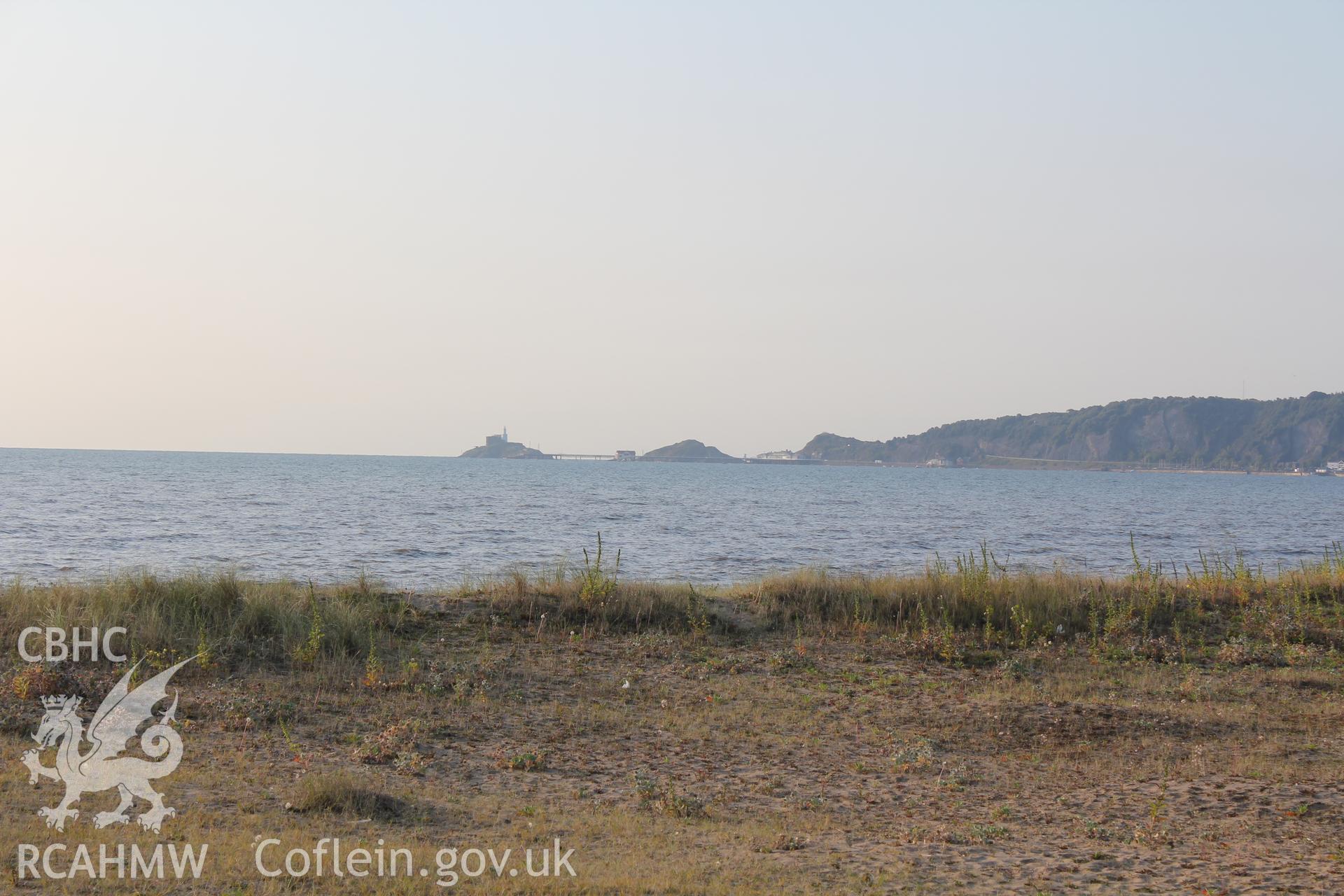 Long distance shot of pier from beach at The Mumbles.