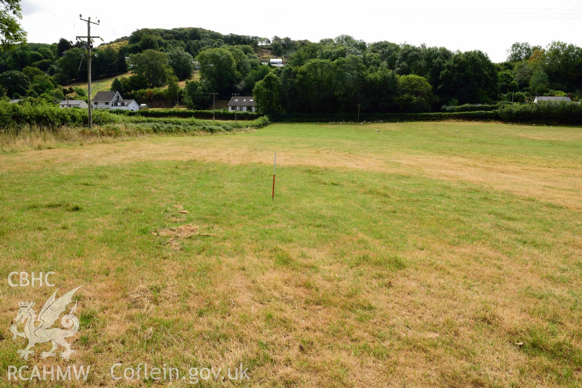 View of south-eastern pit/barrow looking south (scale 1m) at Dollwen barrow cemetery. Photographed by Toby Driver of RCHMAW during BBC filming of The One Show, 17 July 2018. Associated with Geophysical Survey of Pen y Wal, Dollwen Barrow, Goginan, commissioned by the RCAHMW and produced by Sumo Survey, 2021.