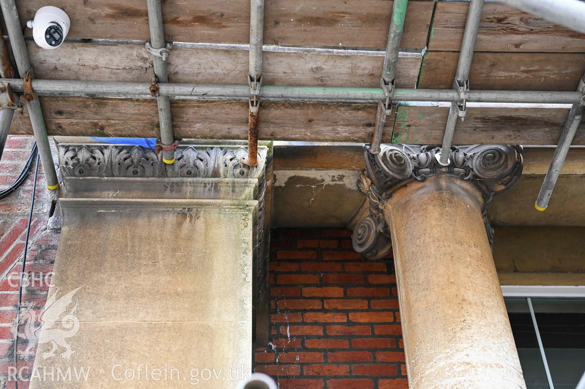 Ionic column volutes and pilaster capital details. Main pedimented fa