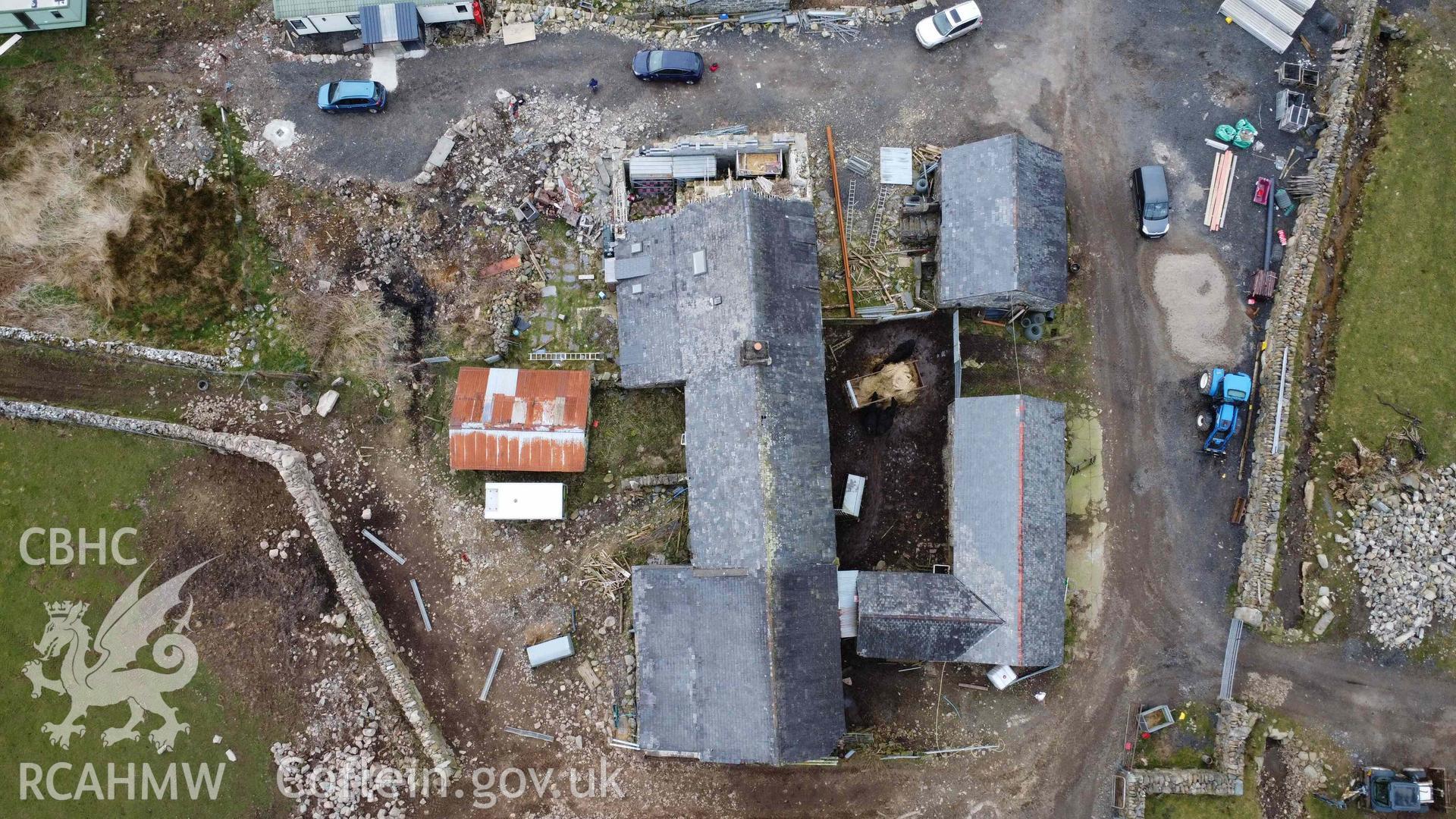 Aerial plan view of Tyddyn Mawr farmhouse and outbuildings. The western gable end can be seen at the top of the photograph. Part of a photographic survey of Tyddyn Mawr farmhouse, Trawsfynydd, conducted by Dr Jayne Kamintzis of RCAHMW on 13 June 2023.