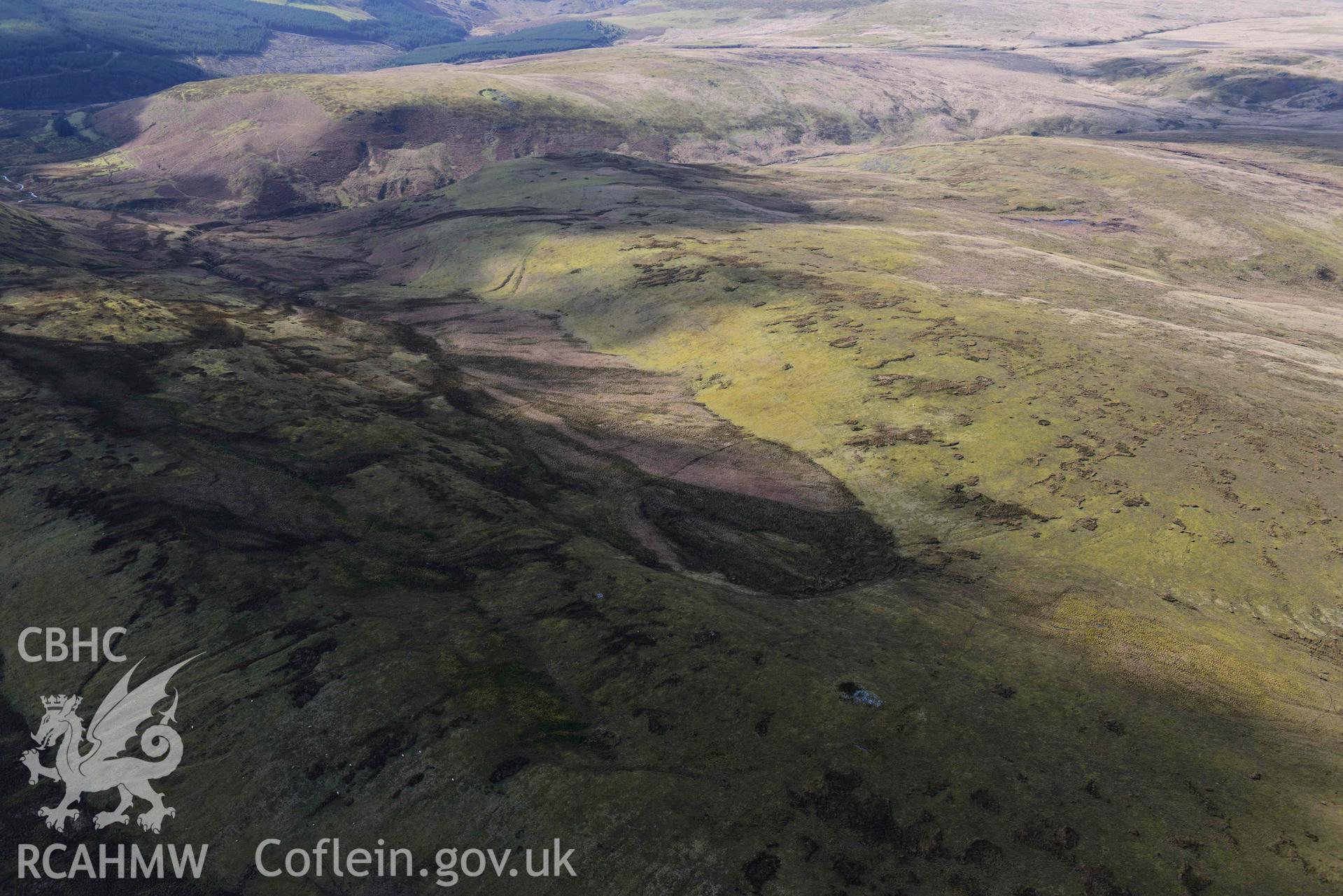 Darren stone pair and cairns, wide view from the east. Oblique aerial photograph taken during the Royal Commission’s programme of archaeological aerial reconnaissance by Toby Driver on 14 March 2022.