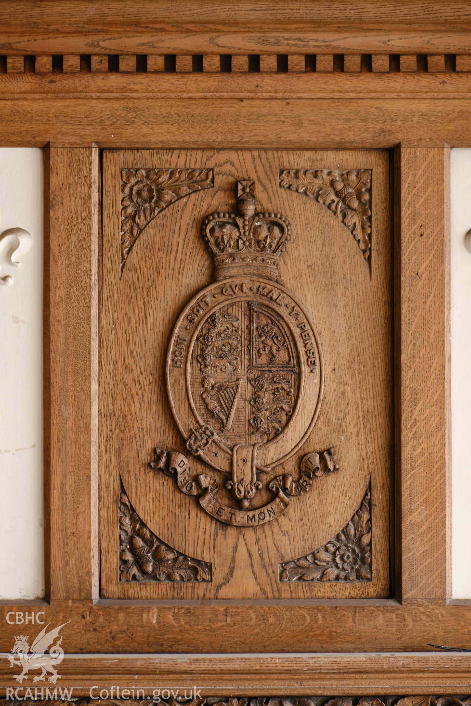 First floor: coat of arms over fireplace.