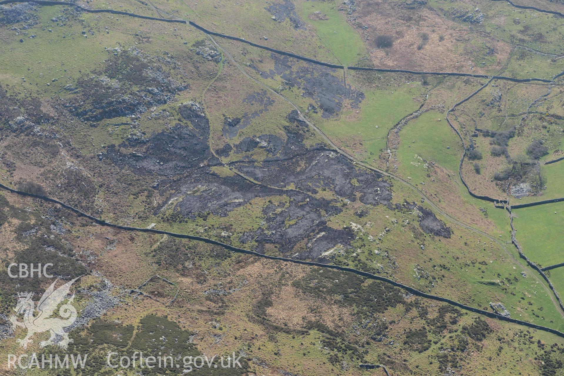 Ffridd Fechan bracken burn. Oblique aerial photograph taken during the Royal Commission’s programme of archaeological aerial reconnaissance by Toby Driver on 25 March 2022.