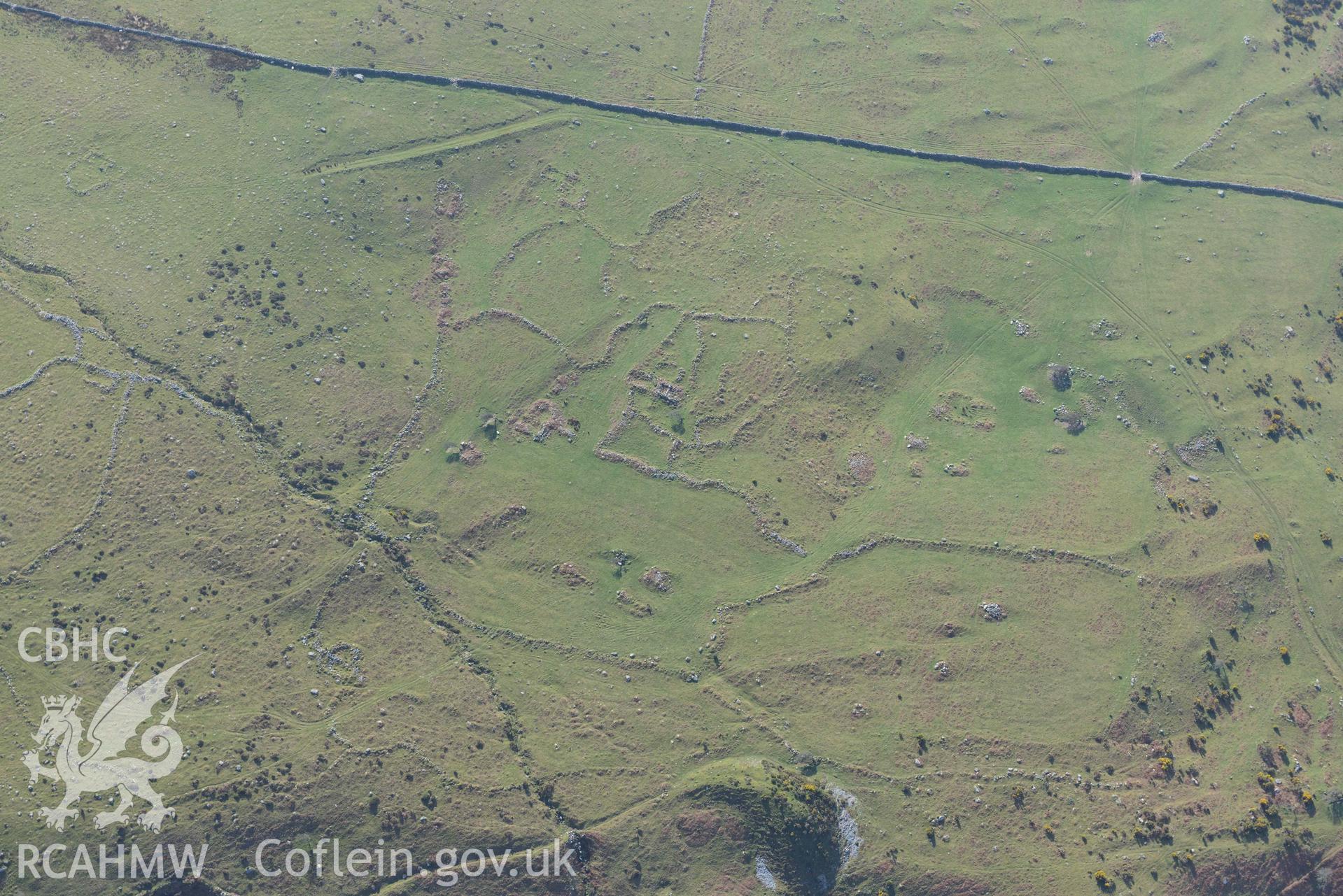 Settlement and fields above Egryn Abbey. Oblique aerial photograph taken during the Royal Commission’s programme of archaeological aerial reconnaissance by Toby Driver on 25 March 2022.