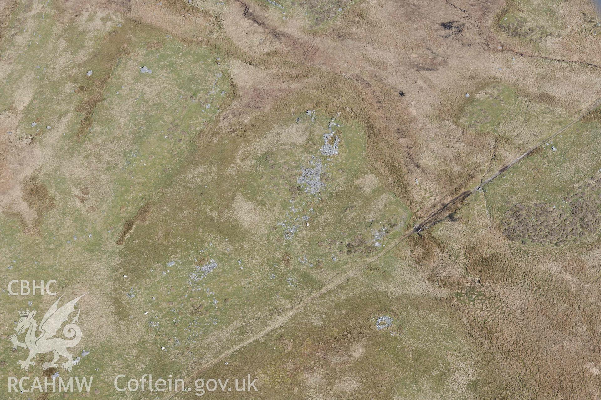 Hut Circle and Enclosure West of Llyn Eiddew Bach. Oblique aerial photographs taken during the Royal Commission’s programme of archaeological aerial reconnaissance by Toby Driver on 25 March 2022.