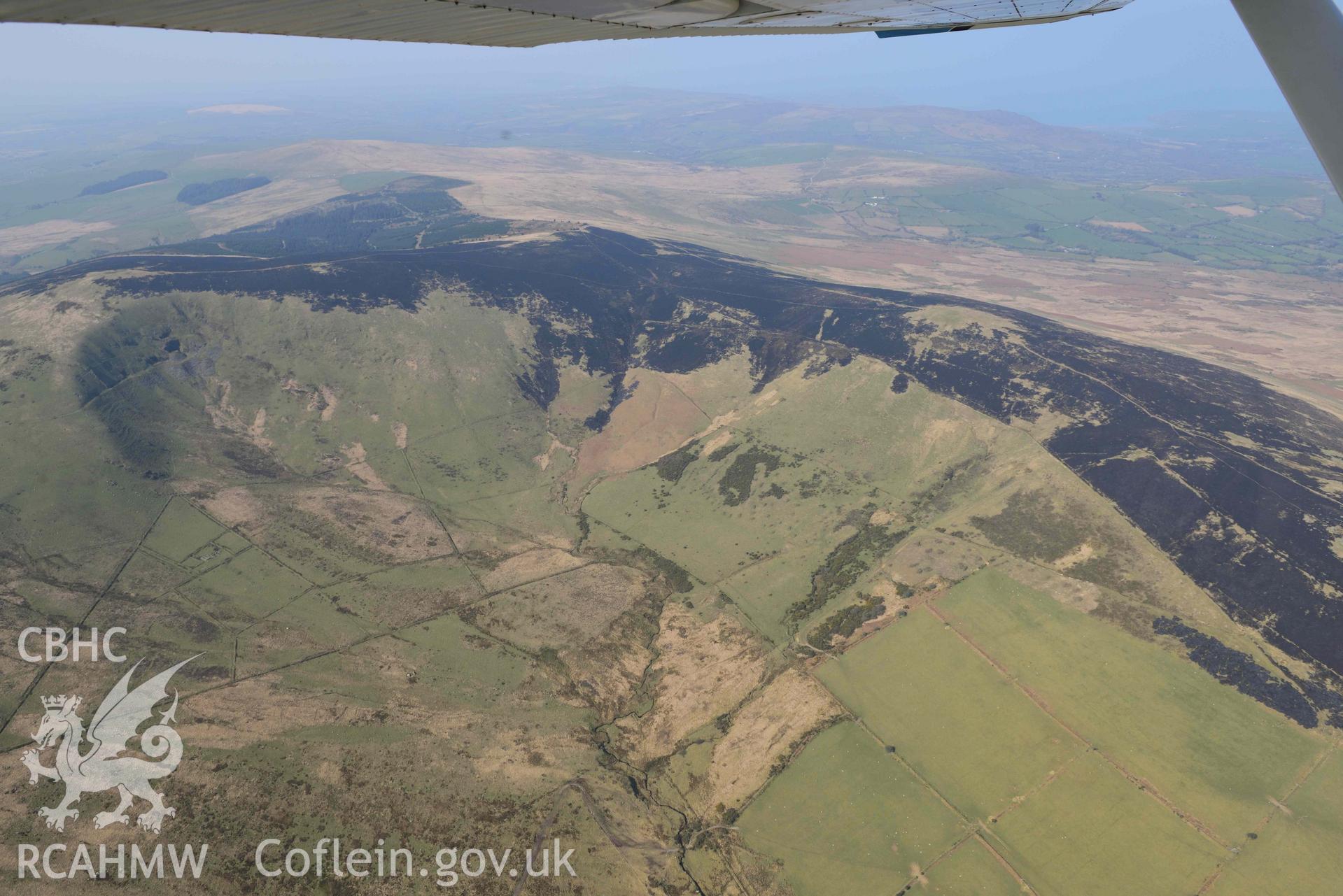 Mynydd Preseli, bracken burn centred on Foel Feddau, view from the south east. Oblique aerial photograph taken during the Royal Commission’s programme of archaeological aerial reconnaissance by Toby Driver on 25 March 2022.