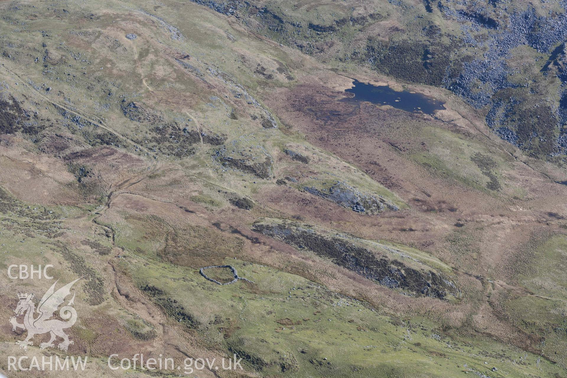 Bryn Cader Faner round cairn, landscape view from the north west. Oblique aerial photograph taken during the Royal Commission’s programme of archaeological aerial reconnaissance by Toby Driver on 25 March 2022.