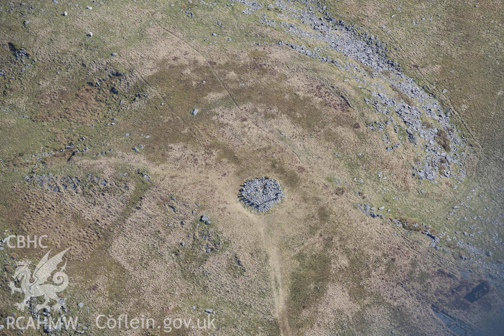 Bryn Cader Faner round cairn. Oblique aerial photograph taken during the Royal Commission’s programme of archaeological aerial reconnaissance by Toby Driver on 25 March 2022.