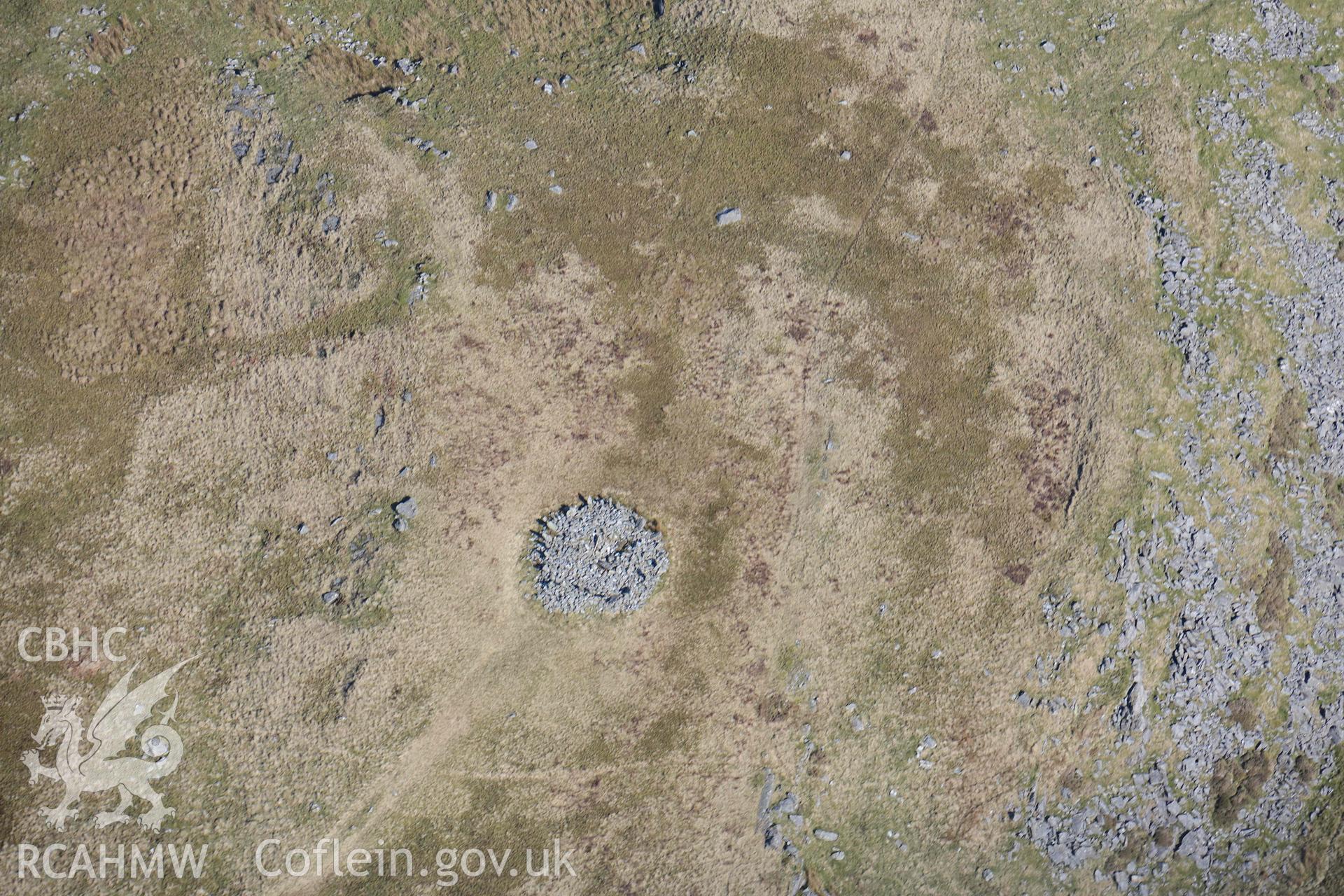 Bryn Cader Faner round cairn. Oblique aerial photograph taken during the Royal Commission’s programme of archaeological aerial reconnaissance by Toby Driver on 25 March 2022.