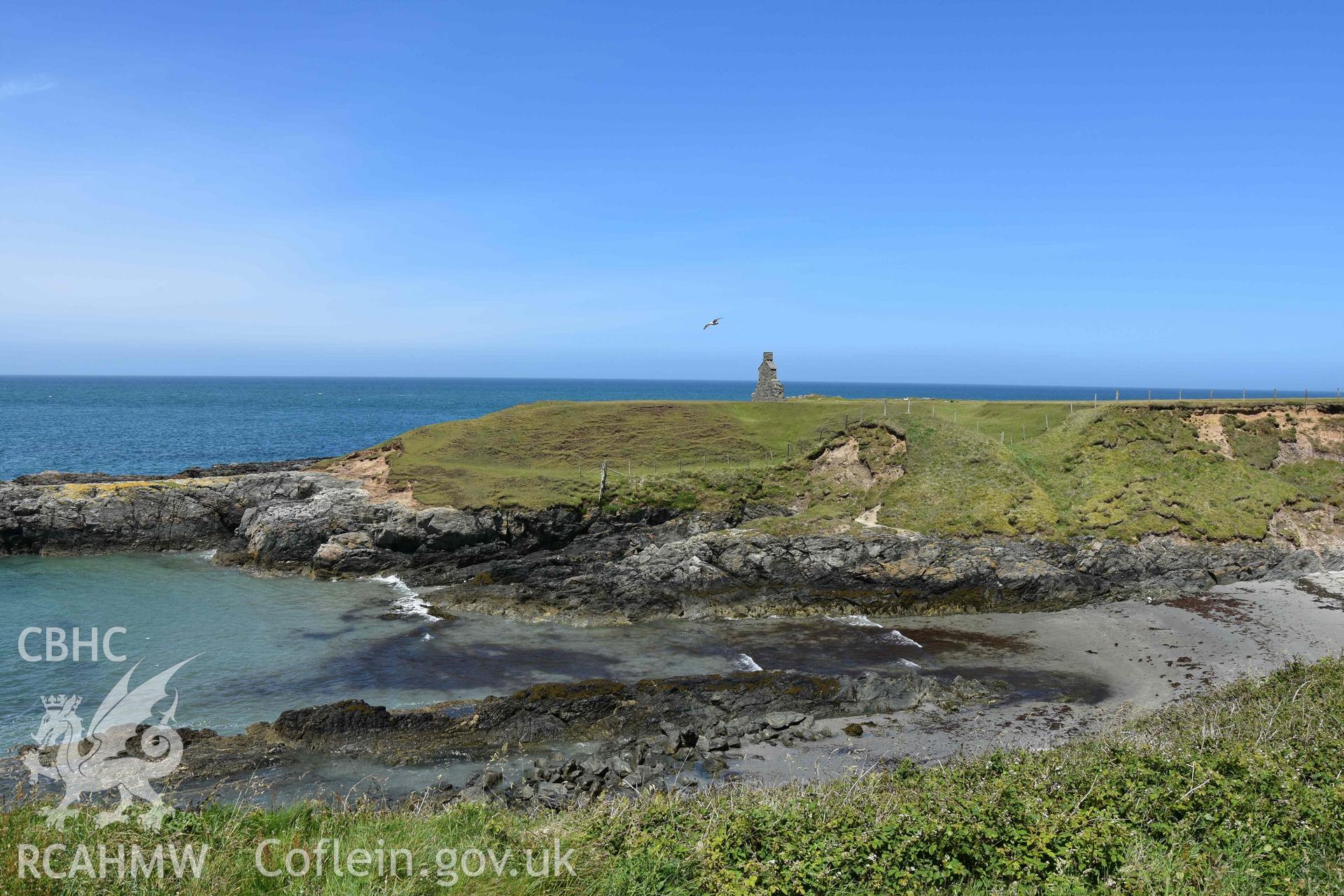 Custom Officer’s House, Porth Ysgaden. Distant view from the south. Photographed by Louise Barker of RCAHMW, 9th June 2017. Produced with EU funds through the Ireland Wales Co-operation Programme 2014-2023. All material made freely available through the Open Government Licence.