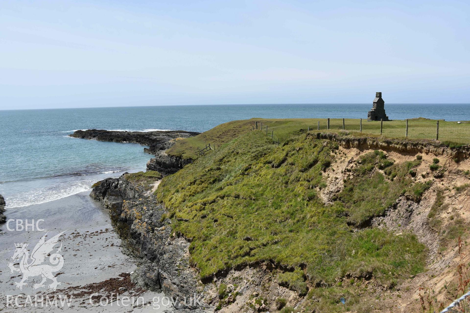 Custom Officer’s House, Porth Ysgaden. Distant view from the east. Photographed by Louise Barker of RCAHMW, 9th June 2017. Produced with EU funds through the Ireland Wales Co-operation Programme 2014-2023. All material made freely available through the Open Government Licence.