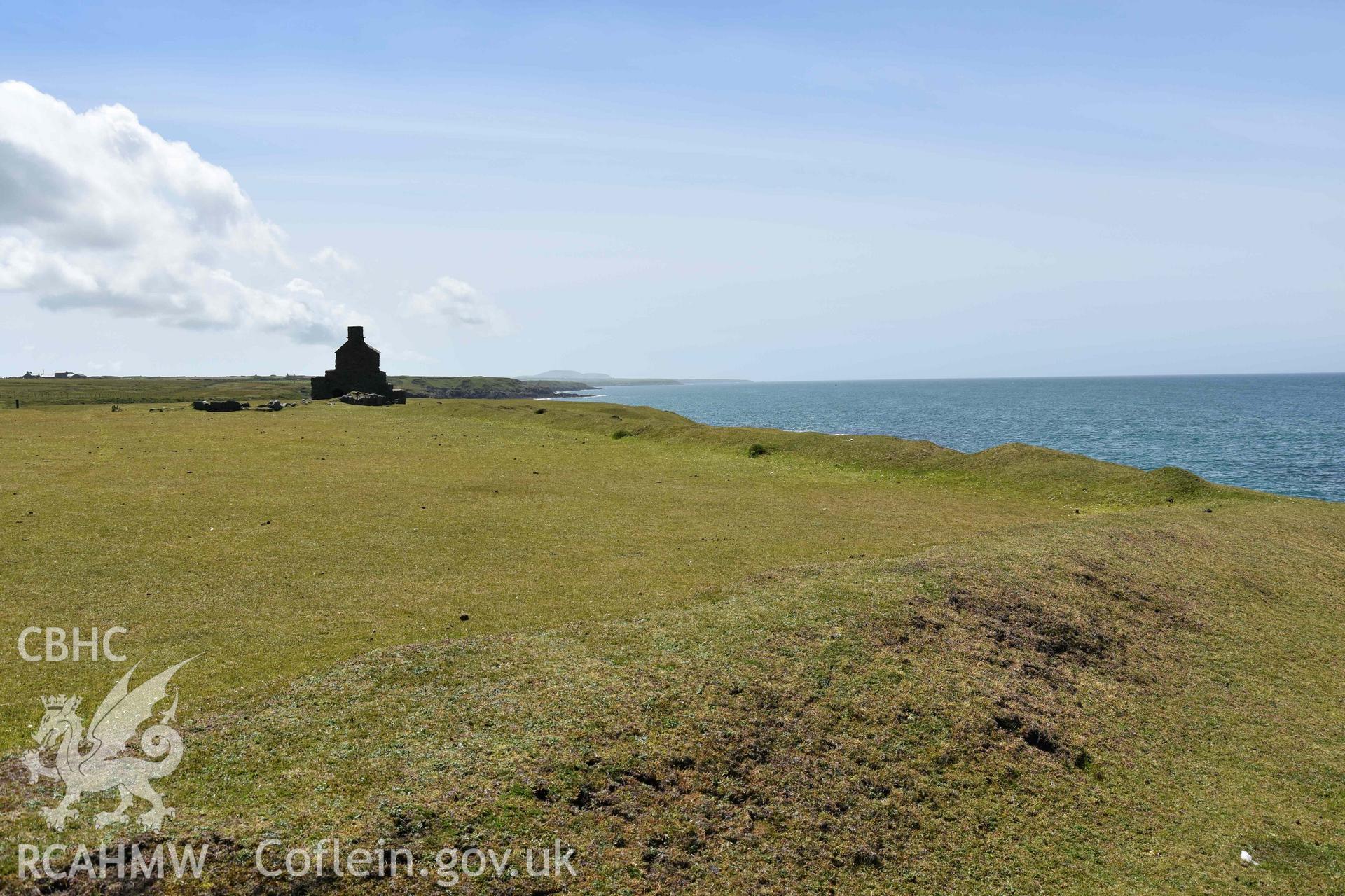 Custom Officer’s House and field boundary, Porth Ysgaden. Distant view from the north. Photographed by Louise Barker of RCAHMW, 9th June 2017. Produced with EU funds through the Ireland Wales Co-operation Programme 2014-2023. All material made freely available through the Open Government Licence.