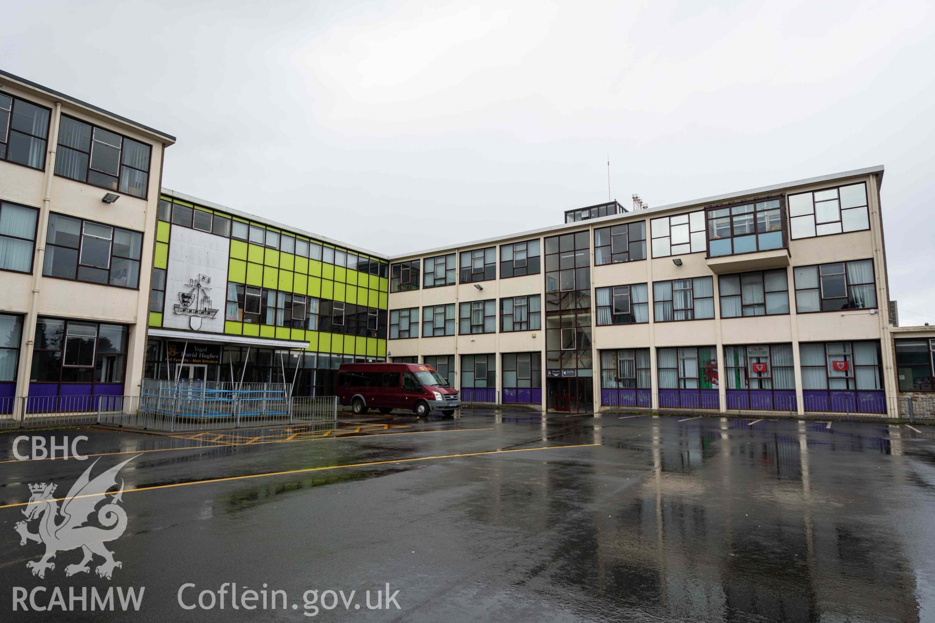 Car park, main entrance and mini bus. Looking west. Ysgol David Hughes