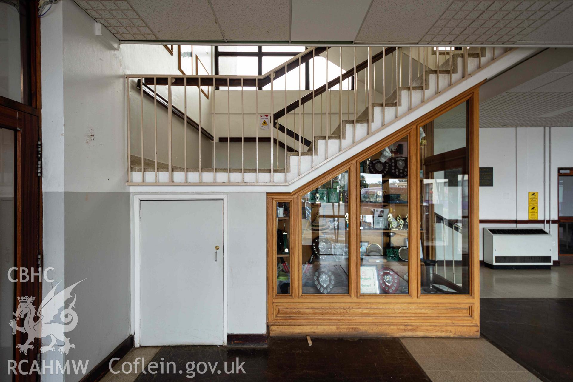 Staircase and trophy cabinet in reception area. Ysgol David Hughes