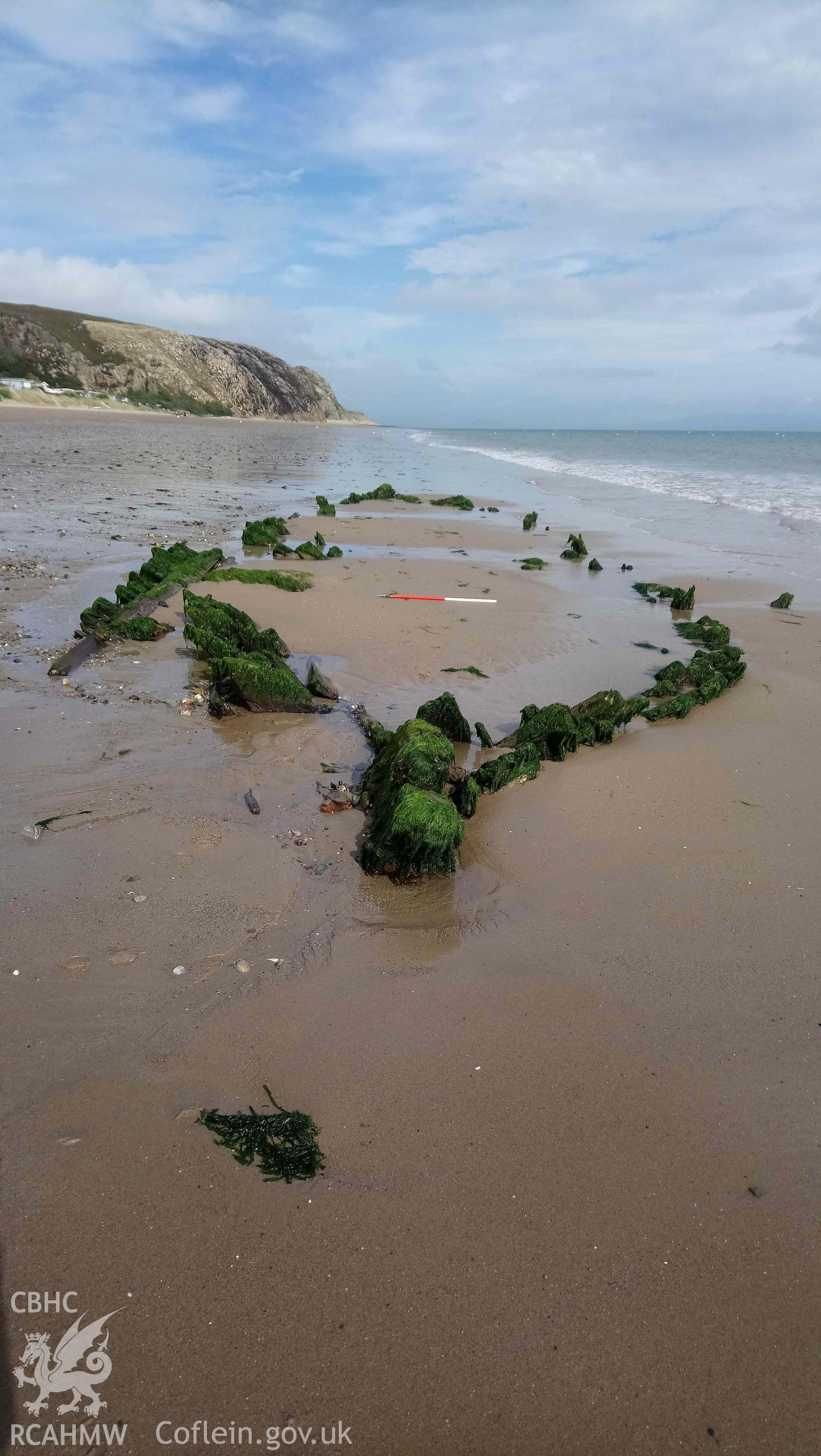 The wreck, looking northeast. Stern in foreground. Part of photographic survey of the Unnamed Wreck (Fosil?) on The Warren Beach, Abersoch, conducted on 11 September 2018 by Daniel Hunt. Crown Copyright. CHERISH project. Produced with EU funds through the Ireland Wales Co-operation Programme 2014-2023. All material made freely available through the Open Government Licence.