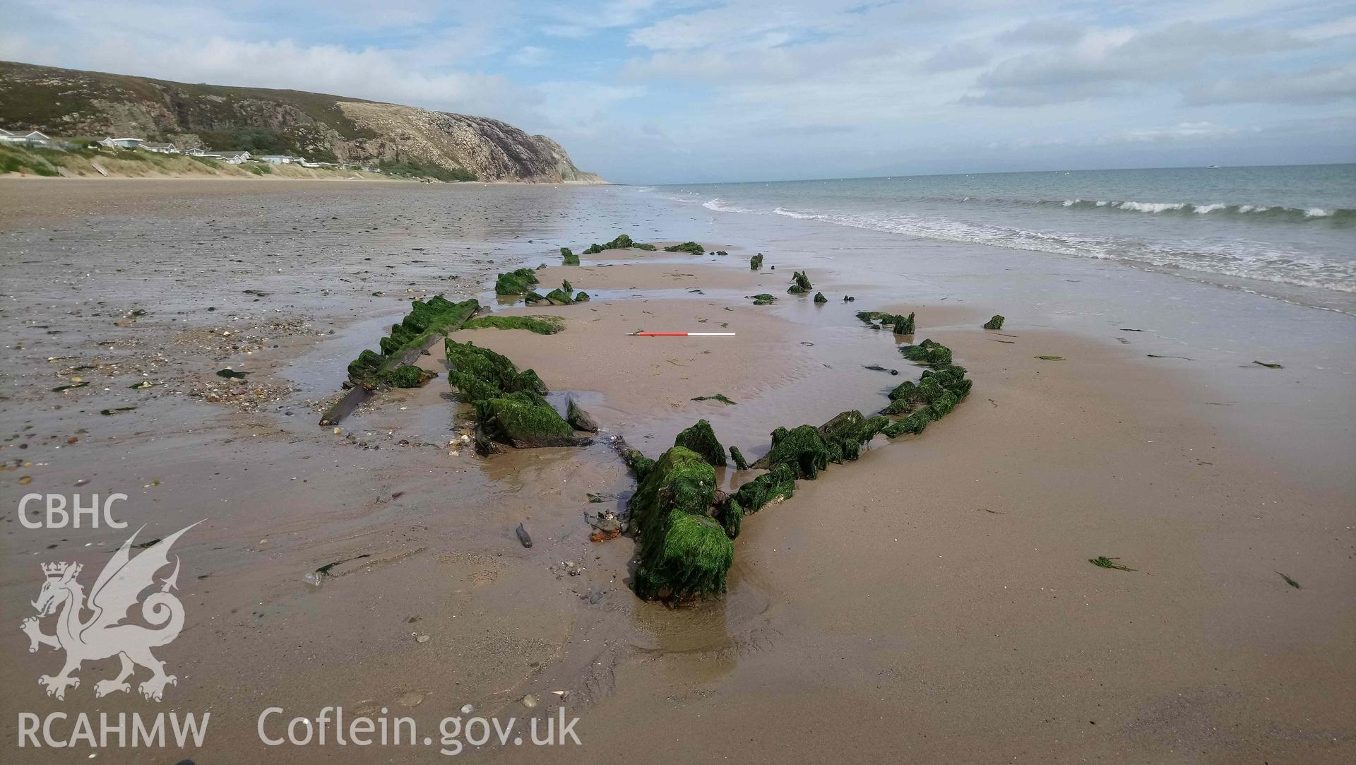 The wreck, looking northeast. Stern in foreground. Part of photographic survey of the Unnamed Wreck (Fosil?) on The Warren Beach, Abersoch, conducted on 11 September 2018 by Daniel Hunt. Crown Copyright. CHERISH project. Produced with EU funds through the Ireland Wales Co-operation Programme 2014-2023. All material made freely available through the Open Government Licence.