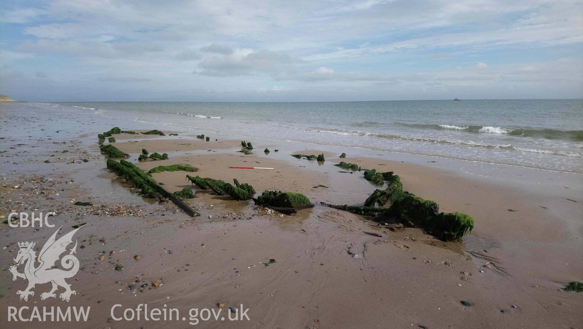 The wreck, looking east. Stern to right. Part of photographic survey of the Unnamed Wreck (Fosil?) on The Warren Beach, Abersoch, conducted on 11 September 2018 by Daniel Hunt. Crown Copyright. CHERISH project. Produced with EU funds through the Ireland Wales Co-operation Programme 2014-2023. All material made freely available through the Open Government Licence.