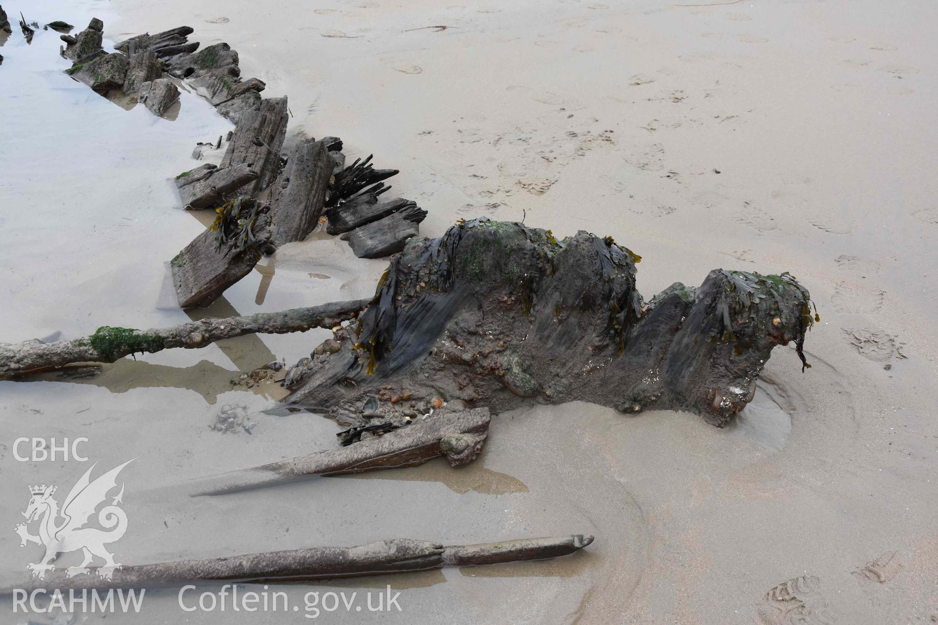 The wreck. Stern from the north. Digital photograph of the Unnamed Wreck (Fosil?) on The Warren Beach, Abersoch, taken by Louise Barker on 23 January 2019. Crown Copyright. CHERISH project. Produced with EU funds through the Ireland Wales Co-operation Programme 2014-2023. All material made freely available through the Open Government Licence.