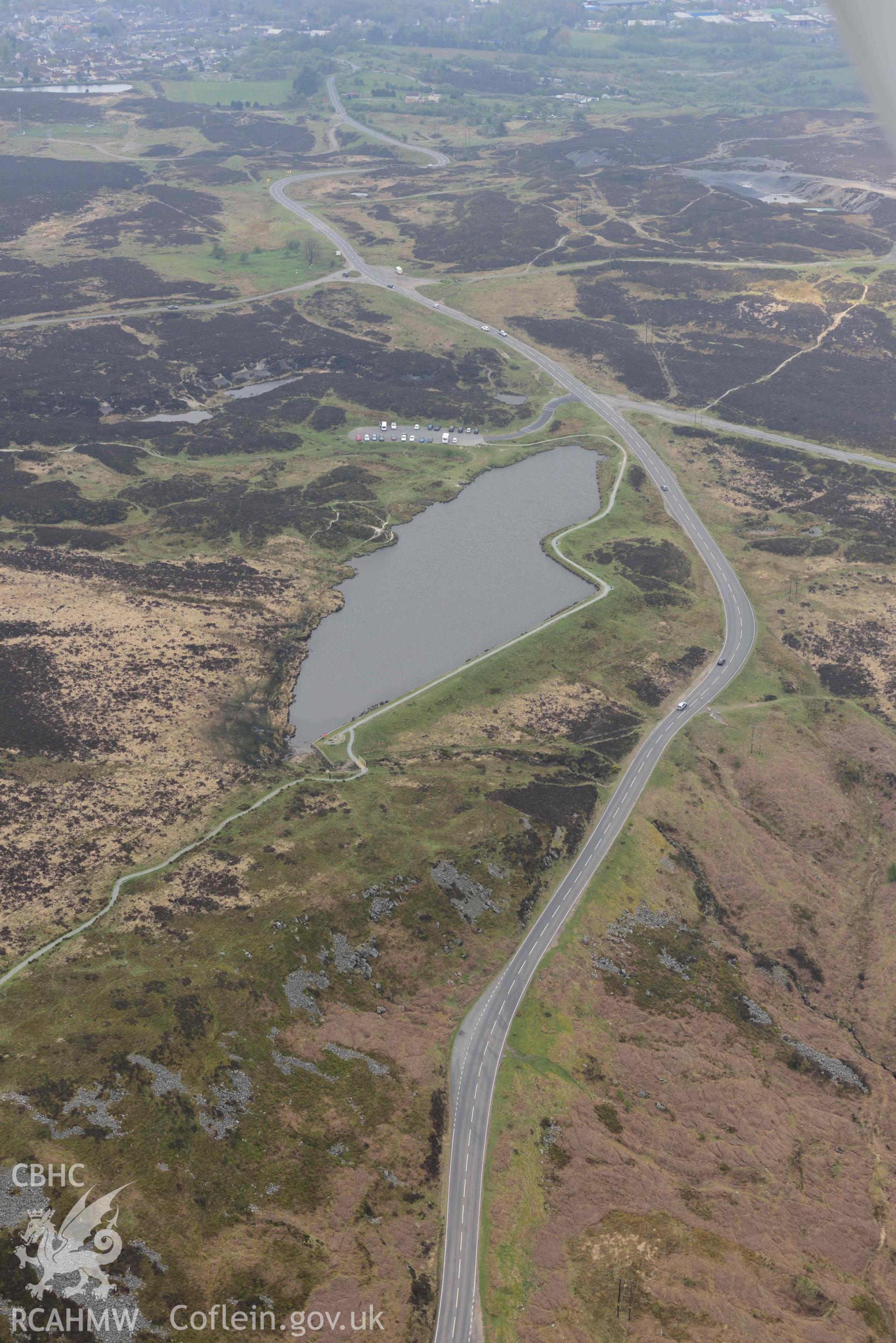 Pen fford goch or Keeper's Pond, in landscape. Oblique aerial photograph taken during the Royal Commission's programme of archaeological aerial reconnaissance by Toby Driver on 29 April 2022.