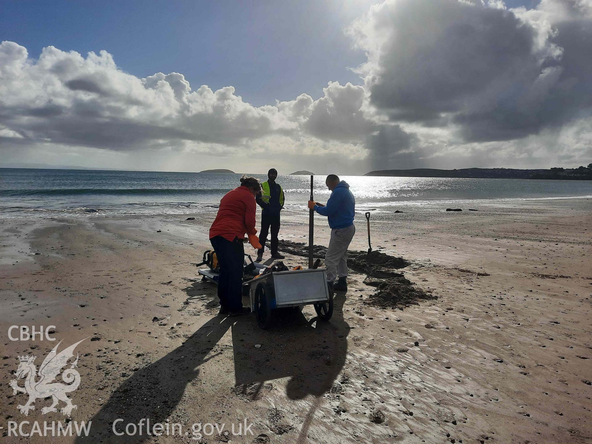 CHERISH sampling the peat. Part of a survey of the Submerged Forest, Peat Exposures and Footprints on The Warren Beach, Abersoch, conducted by Louise Barker on 21 October 2021. Produced with EU funds through the Ireland Wales Co-operation Programme 2014-2023. All material made freely available through the Open Government Licence.