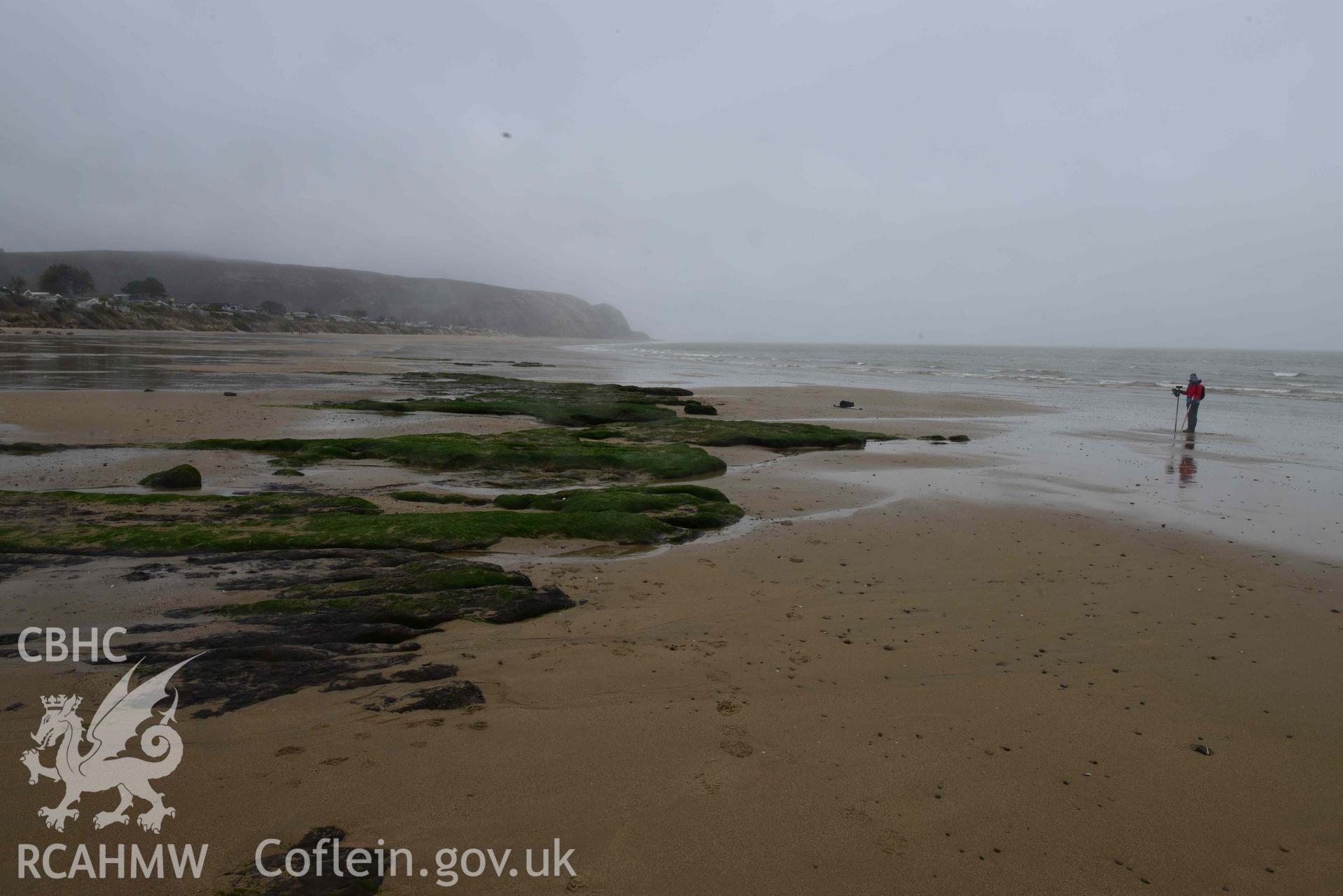 Peat exposure.  View looking northeast. Part of survey of the Submerged Forest, Peat Exposures and Footprints on The Warren Beach, Abersoch, conducted by Toby Driver on 29 March 2021. Produced with EU funds through the Ireland Wales Co-operation Programme 2014-2023. All material made freely available through the Open Government Licence.