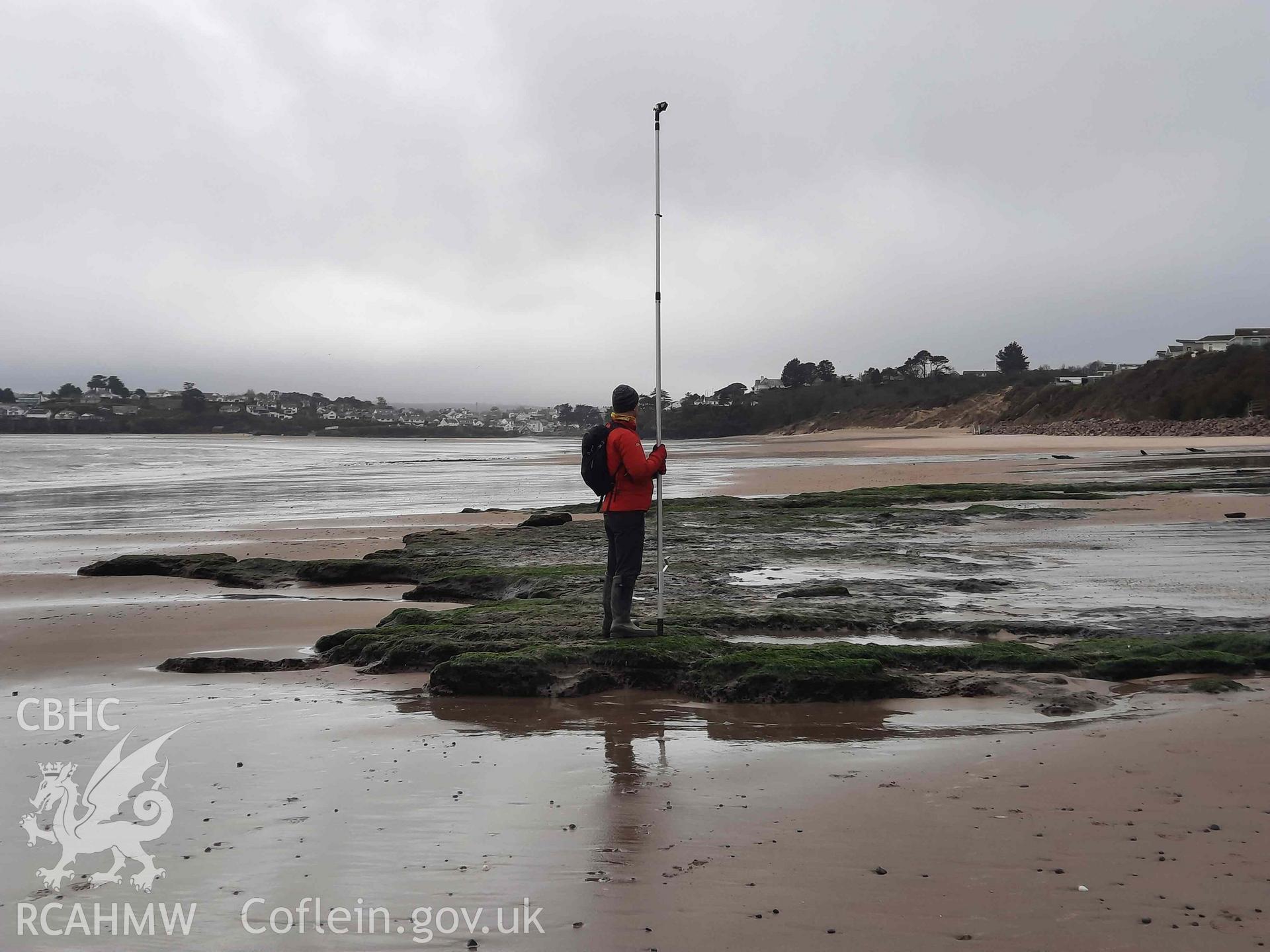 CHERISH recording the peat exposure with a pole camera. Part of survey of the Submerged Forest, Peat Exposures and Footprints on The Warren Beach, Abersoch, conducted by Louise Barker on 29 March 2021. Produced with EU funds through the Ireland Wales Co-operation Programme 2014-2023. All material made freely available through the Open Government Licence.