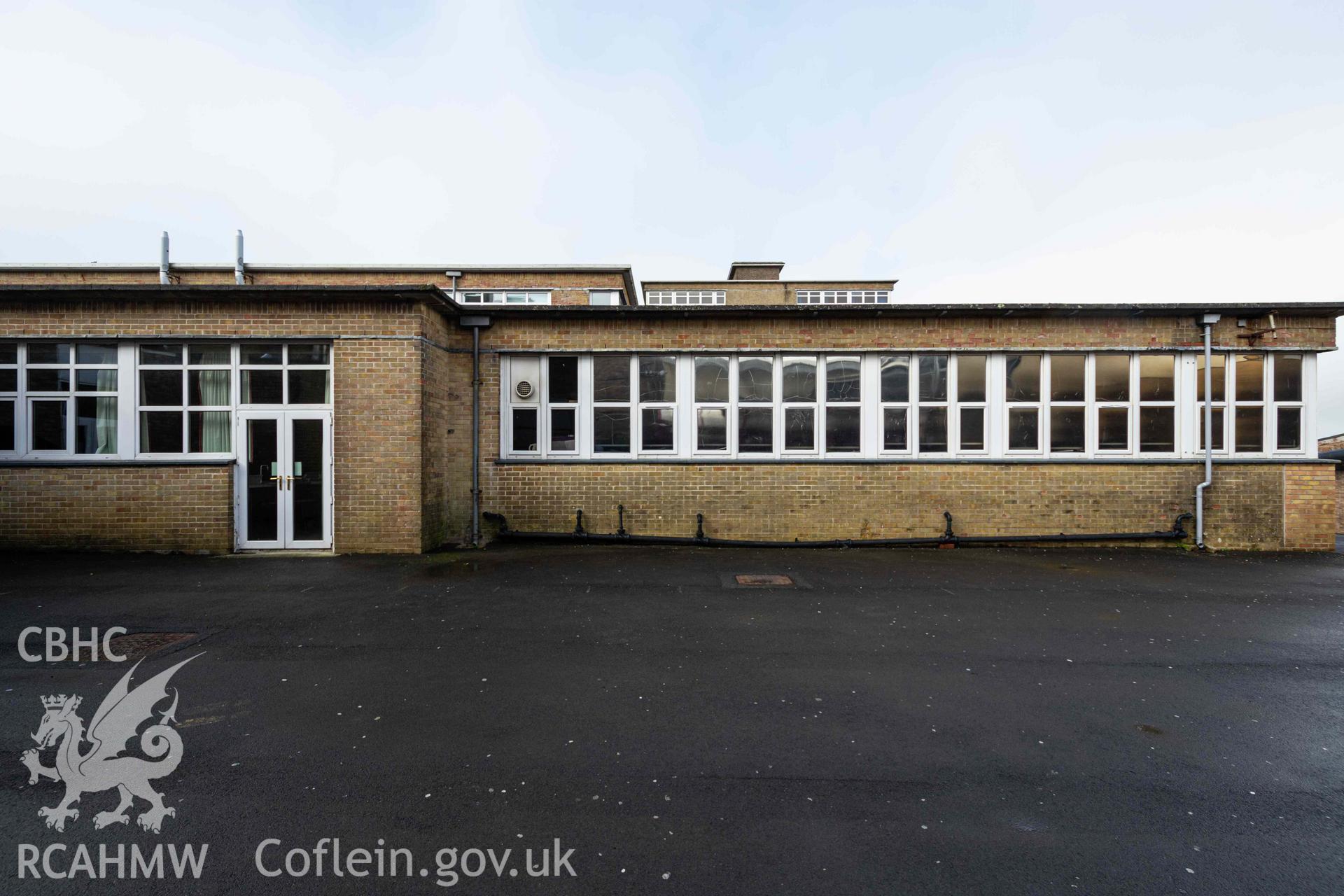 Building form, flat roof, glazing, brick, doorway. Looking west. Ysgol Bro Preseli