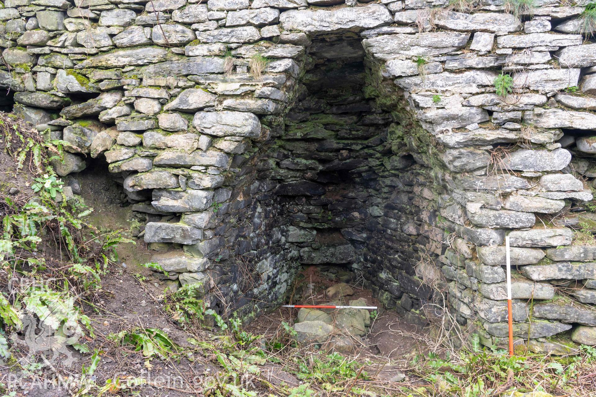 Kiln 2, kiln-eye, east elevation (with scale). Part of photographic survey of Aberstrincell lime kilns and coal yard, conducted by Louise Barker of the RCAHMW survey team on 21 March 2024.