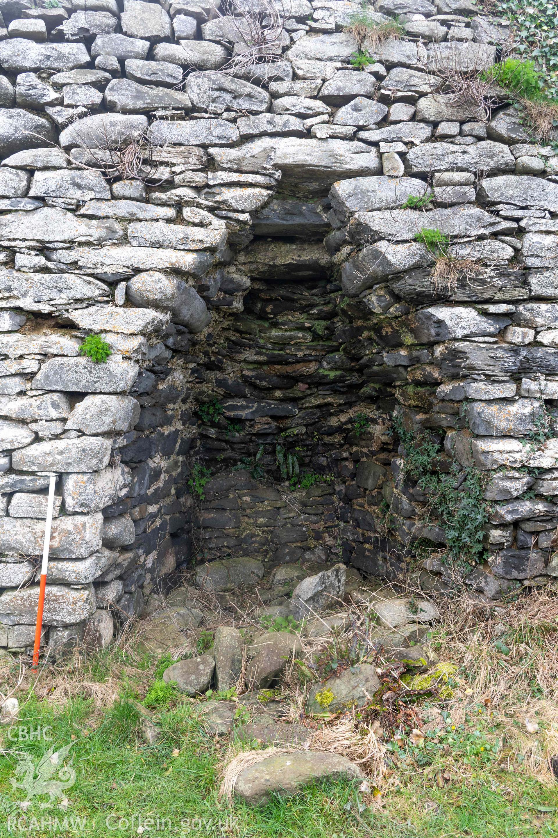 Kiln 2, kiln-eye, north elevation (with scale). Part of photographic survey of Aberstrincell lime kilns and coal yard, conducted by Louise Barker of the RCAHMW survey team on 21 March 2024.