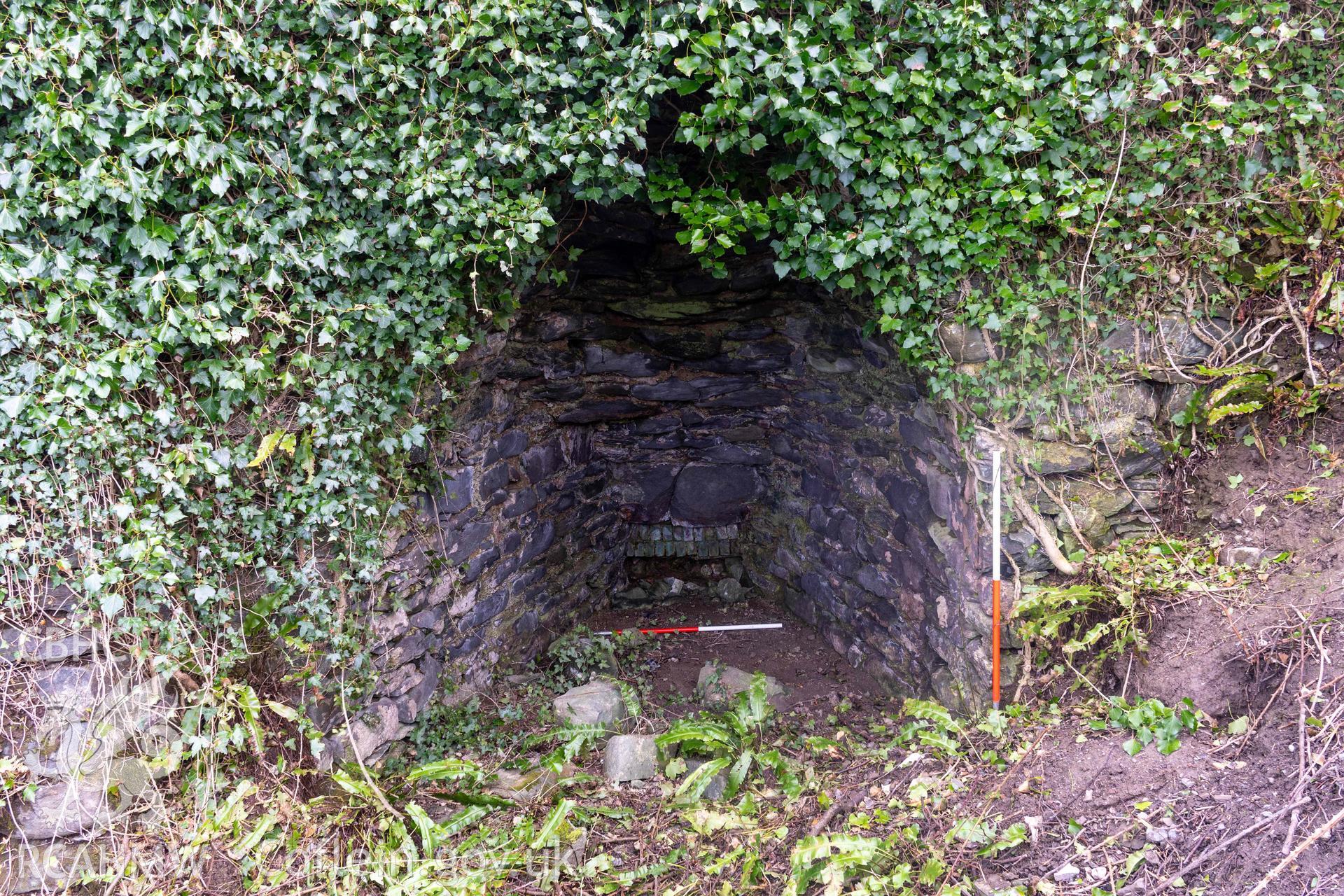 Kiln 2, kiln-eye west elevation (with scale). Part of photographic survey of Aberstrincell lime kilns and coal yard, conducted by Louise Barker of the RCAHMW survey team on 21 March 2024.