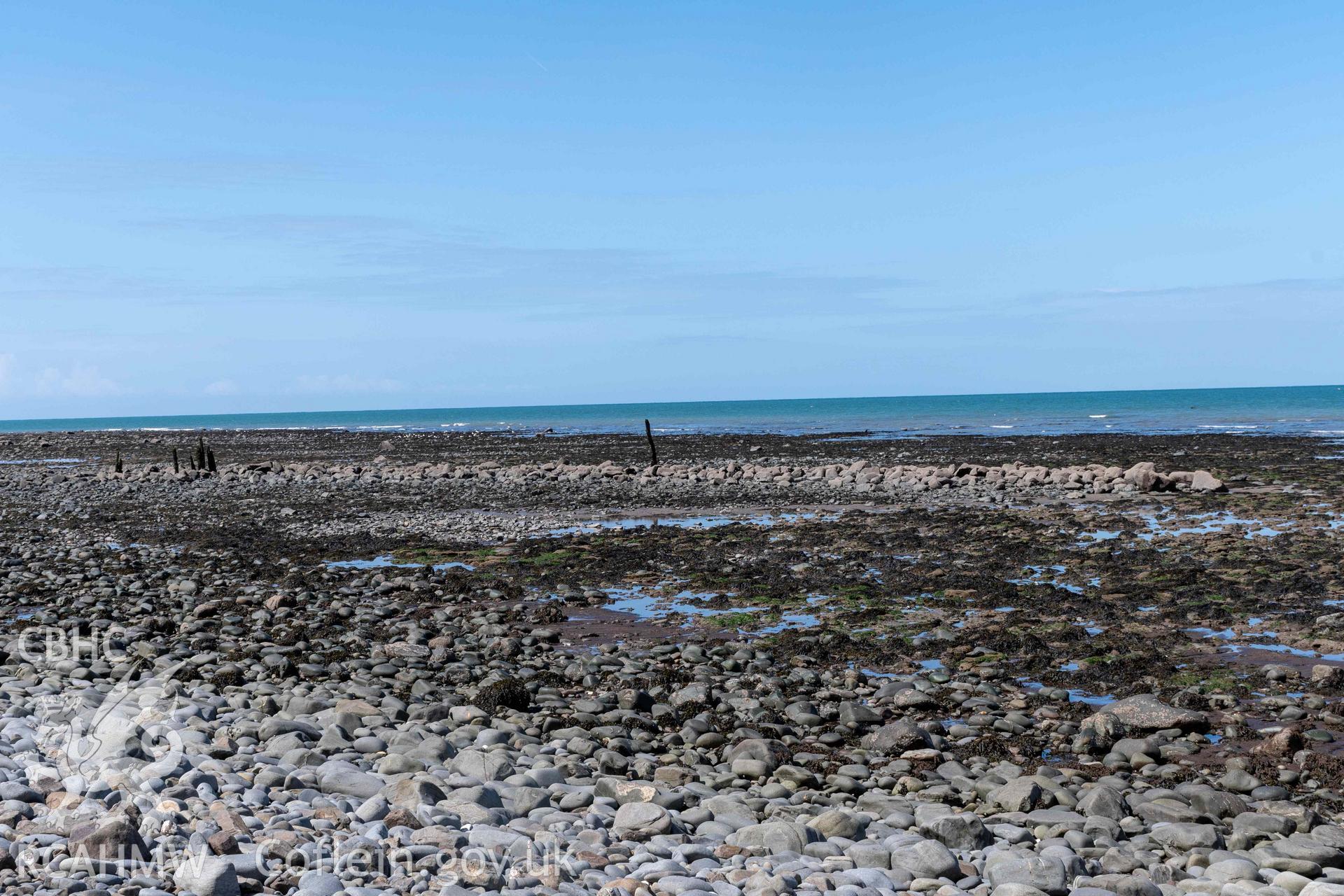 Northeast arm of breakwater from the south. Part of photographic survey of Aberstrincell lime kilns and coal yard, conducted by Louise Barker of the RCAHMW survey team on 21 March 2024.