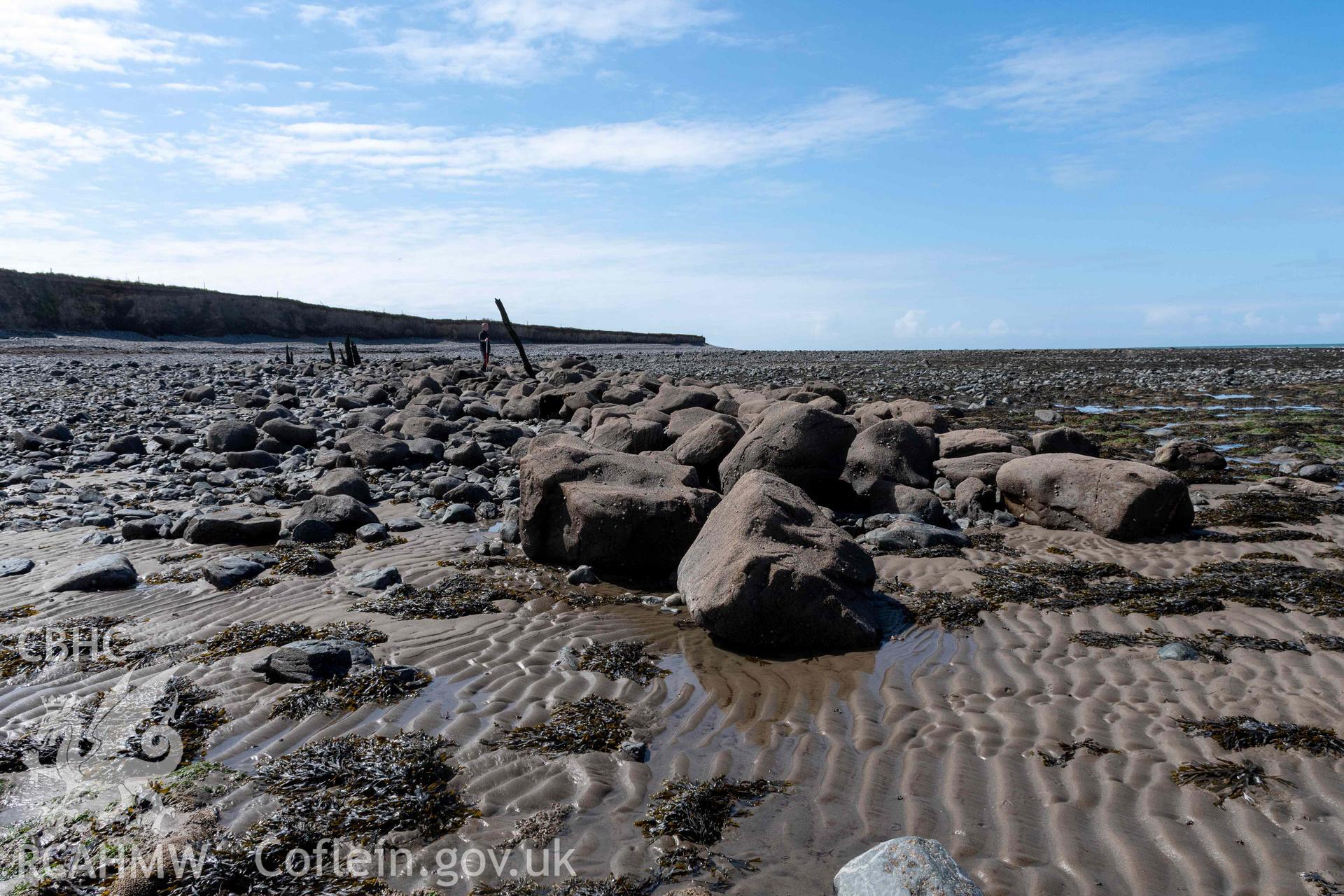 Northeast arm of breakwater at terminus from the northeast. Part of photographic survey of Aberstrincell lime kilns and coal yard, conducted by Louise Barker of the RCAHMW survey team on 21 March 2024.