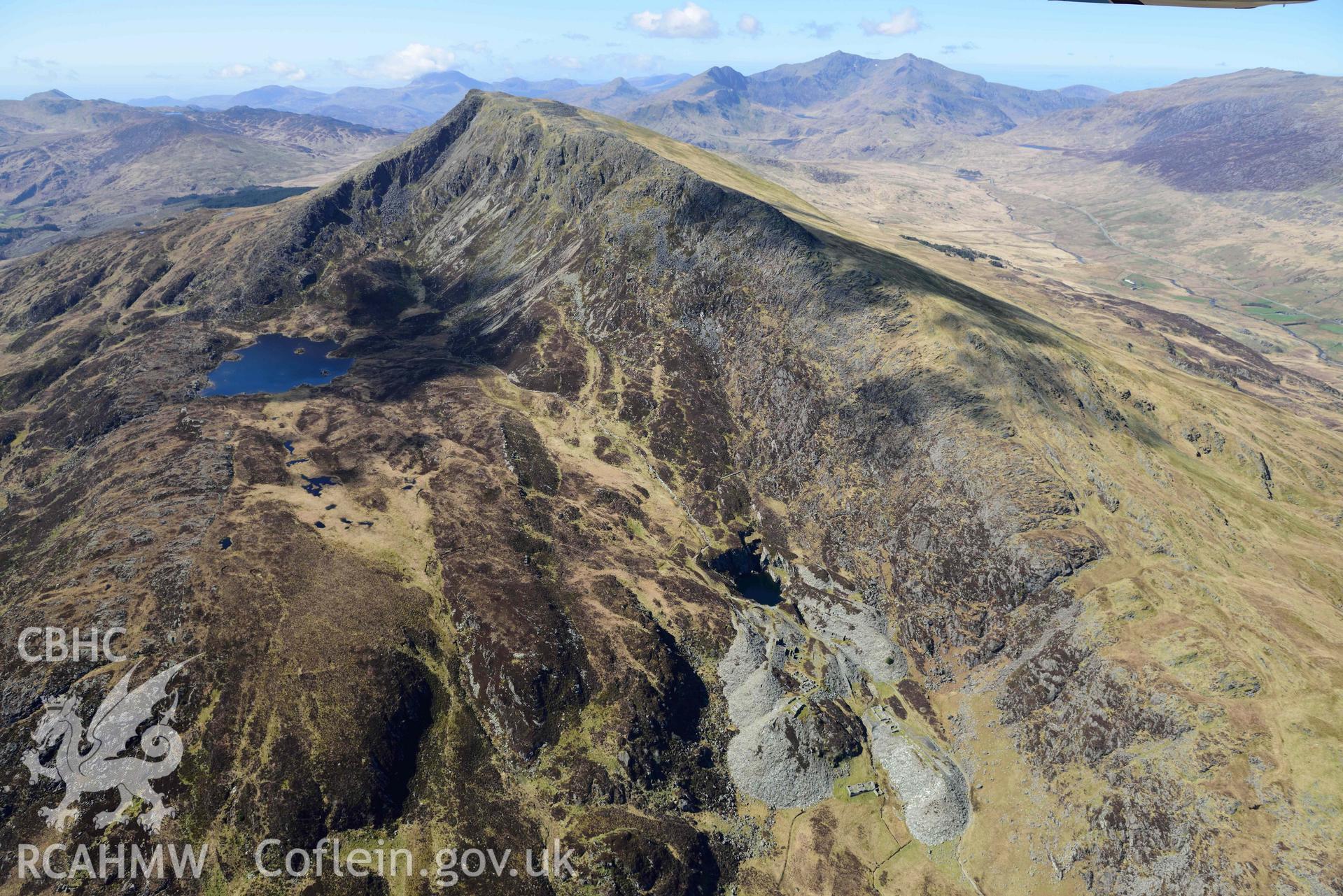 Moel Siabod Slate and Slab works, view from north-east with Moel Siabod. Oblique aerial photograph taken during the Royal Commission’s programme of archaeological aerial reconnaissance by Toby Driver on 20 April 2018.