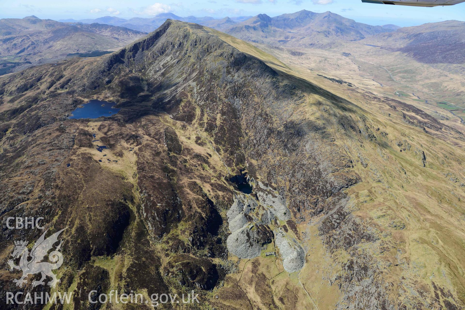 Moel Siabod Slate and Slab works, view from north-east with Moel Siabod. Oblique aerial photograph taken during the Royal Commission’s programme of archaeological aerial reconnaissance by Toby Driver on 20 April 2018.